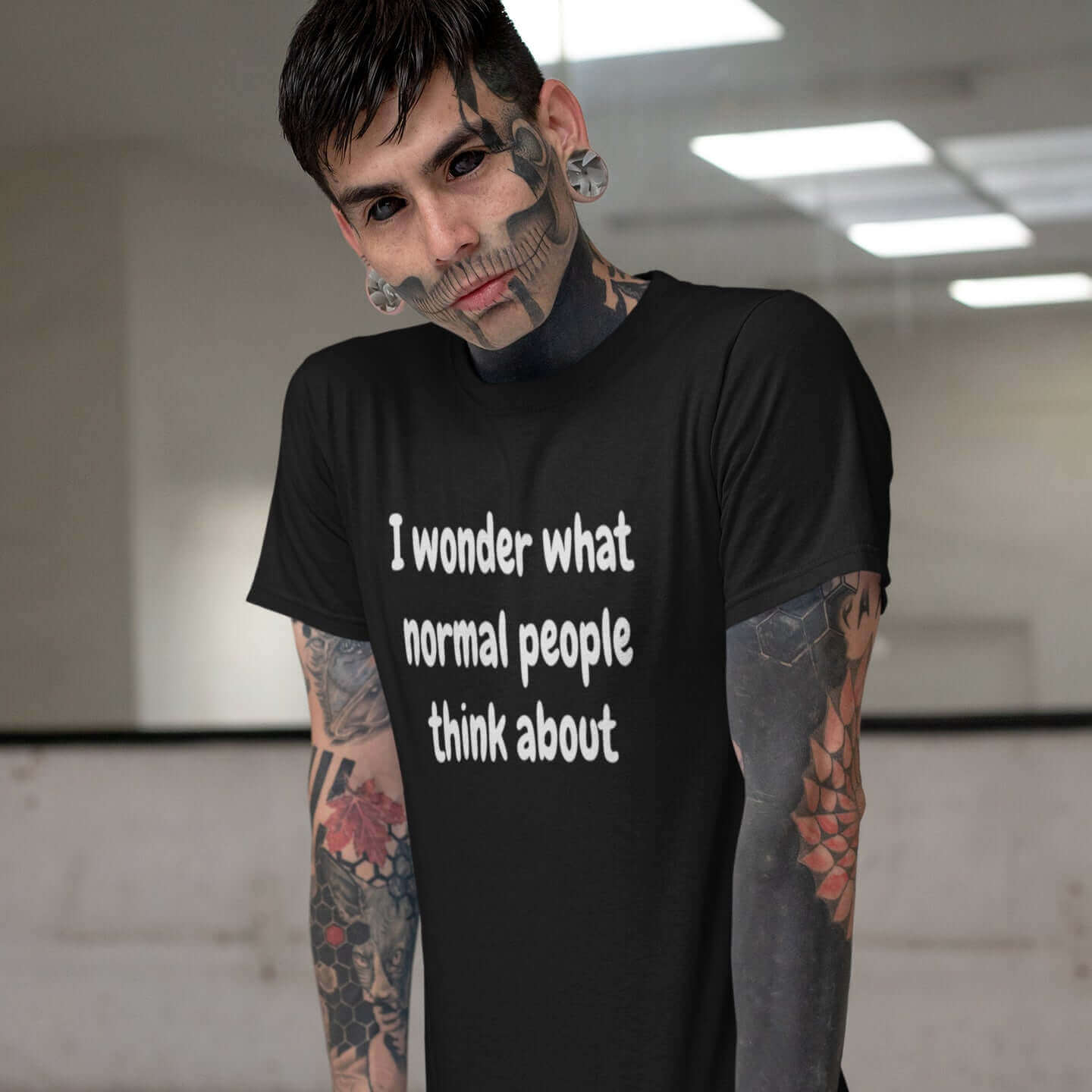 edgy tattooed man with face tattoos wearing black tshirt I wonder what normal people think about witticismsrus