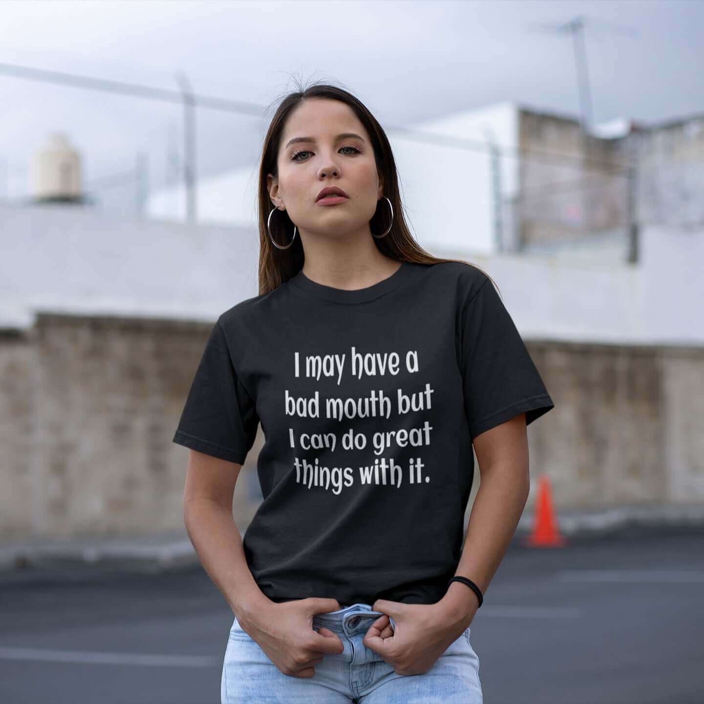 Woman wearing a black t-shirt with the phrase I may have a bad mouth but I can do great things with it printed on the front.