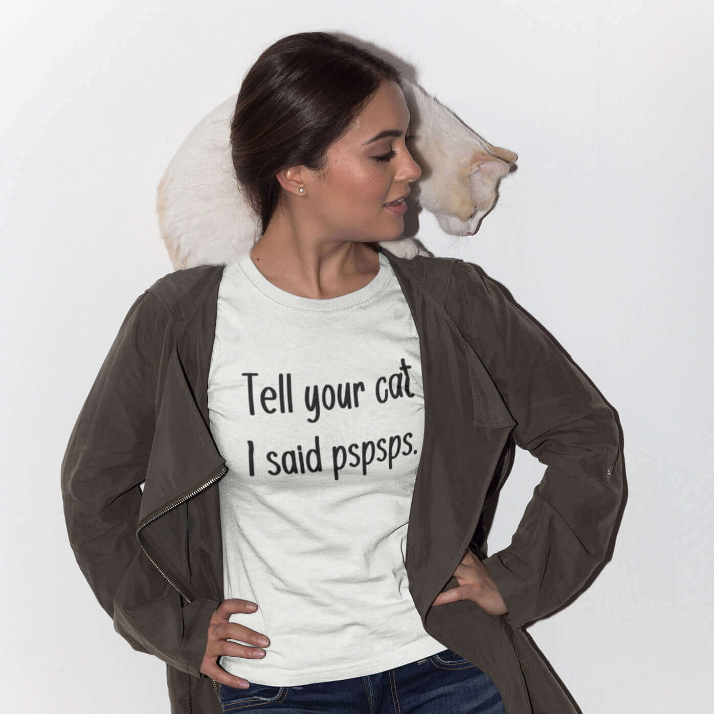 Woman with a cat wearing a white t-shirt with the words Tell your cat I said pspsps printed on the front.