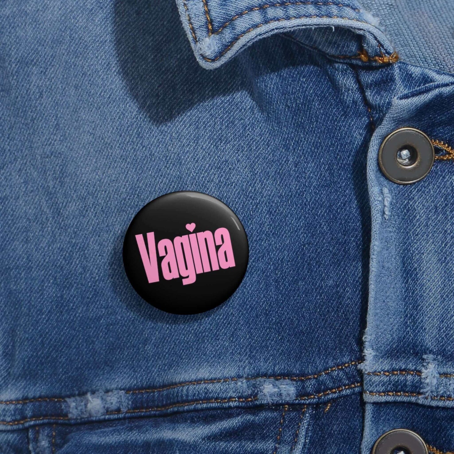 Black pinback button with the word Vagina printed in pink.