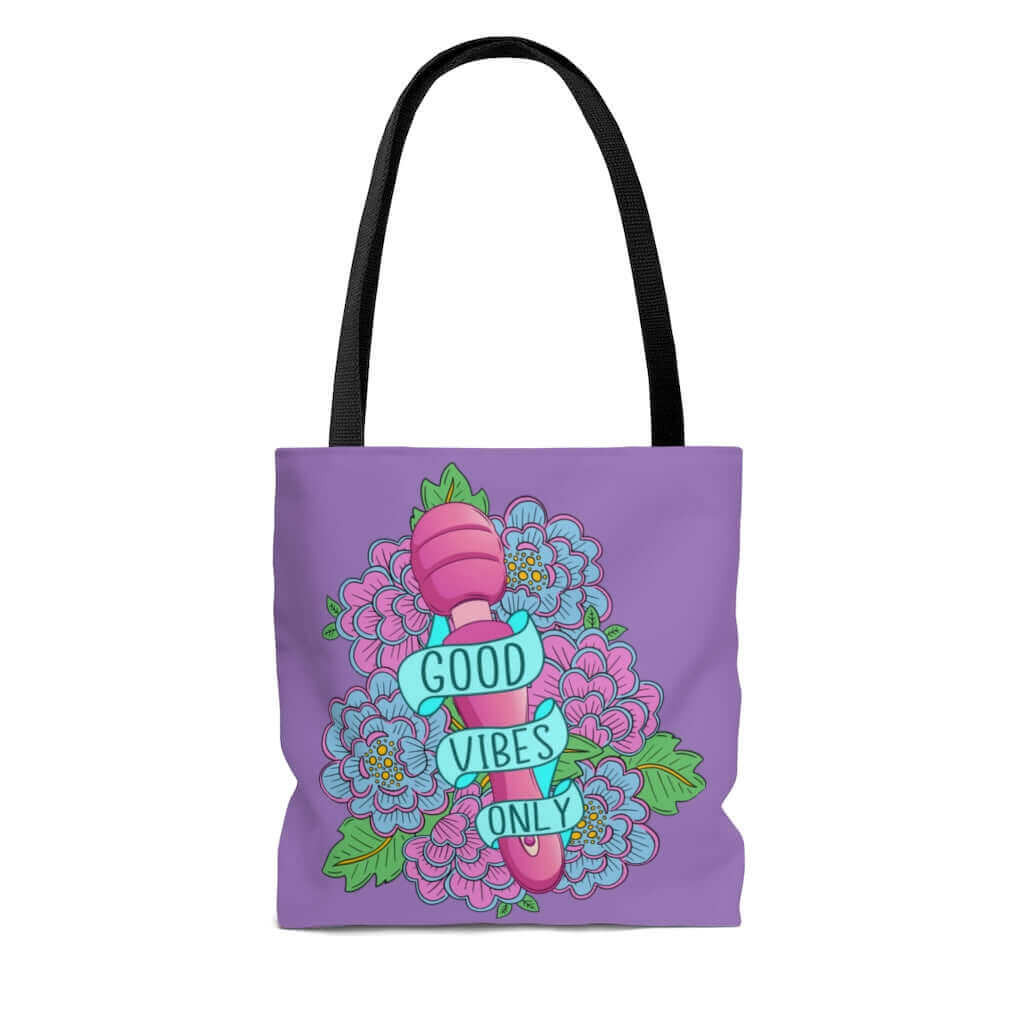 Light purple tote bag with graphic that has the words Good vibes only layered over a pink wand vibrator with flowers around. The graphic design is printed on both sides of the tote bag.