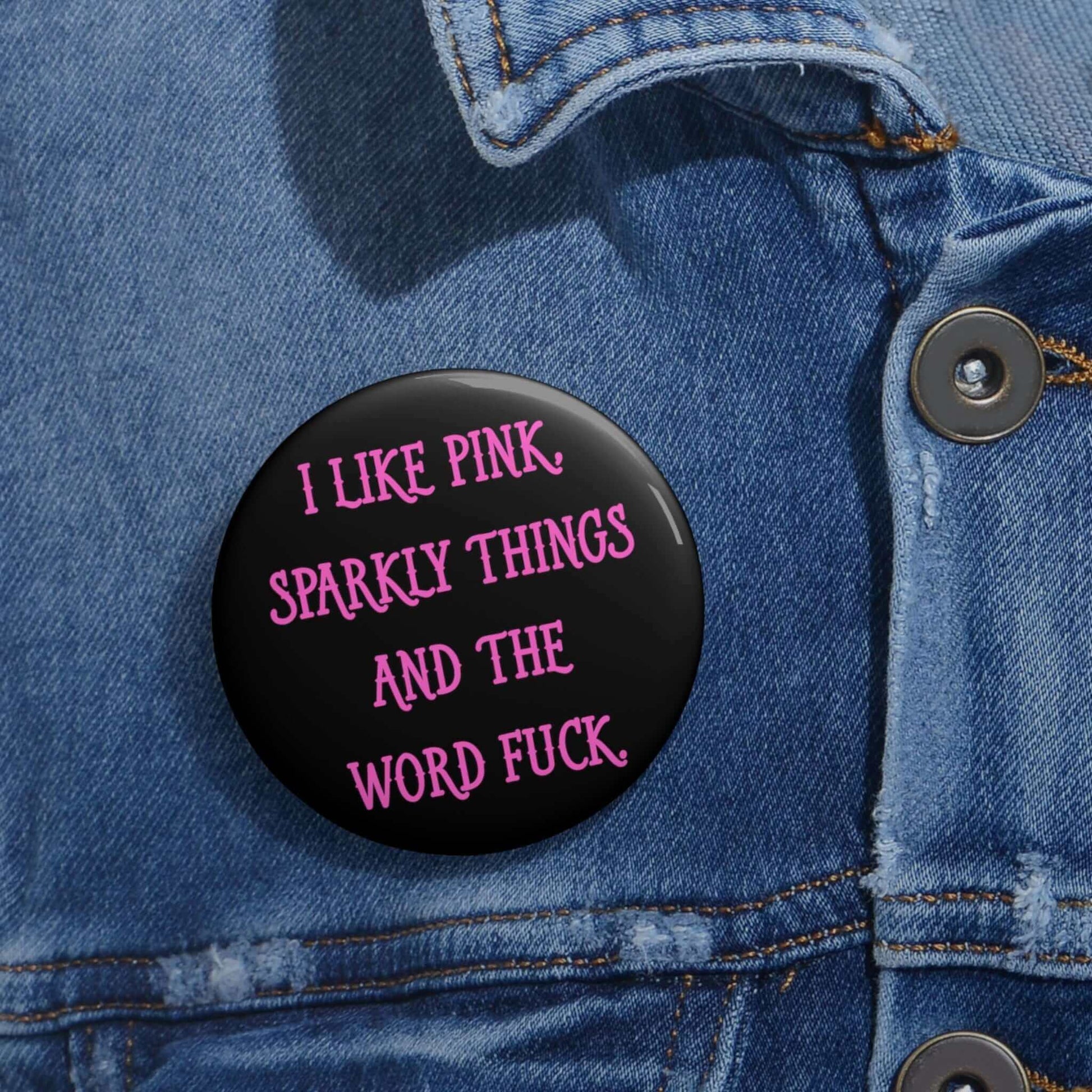 Pin-back button that says I like pink, sparkly things and the word fuck printed in pink font.