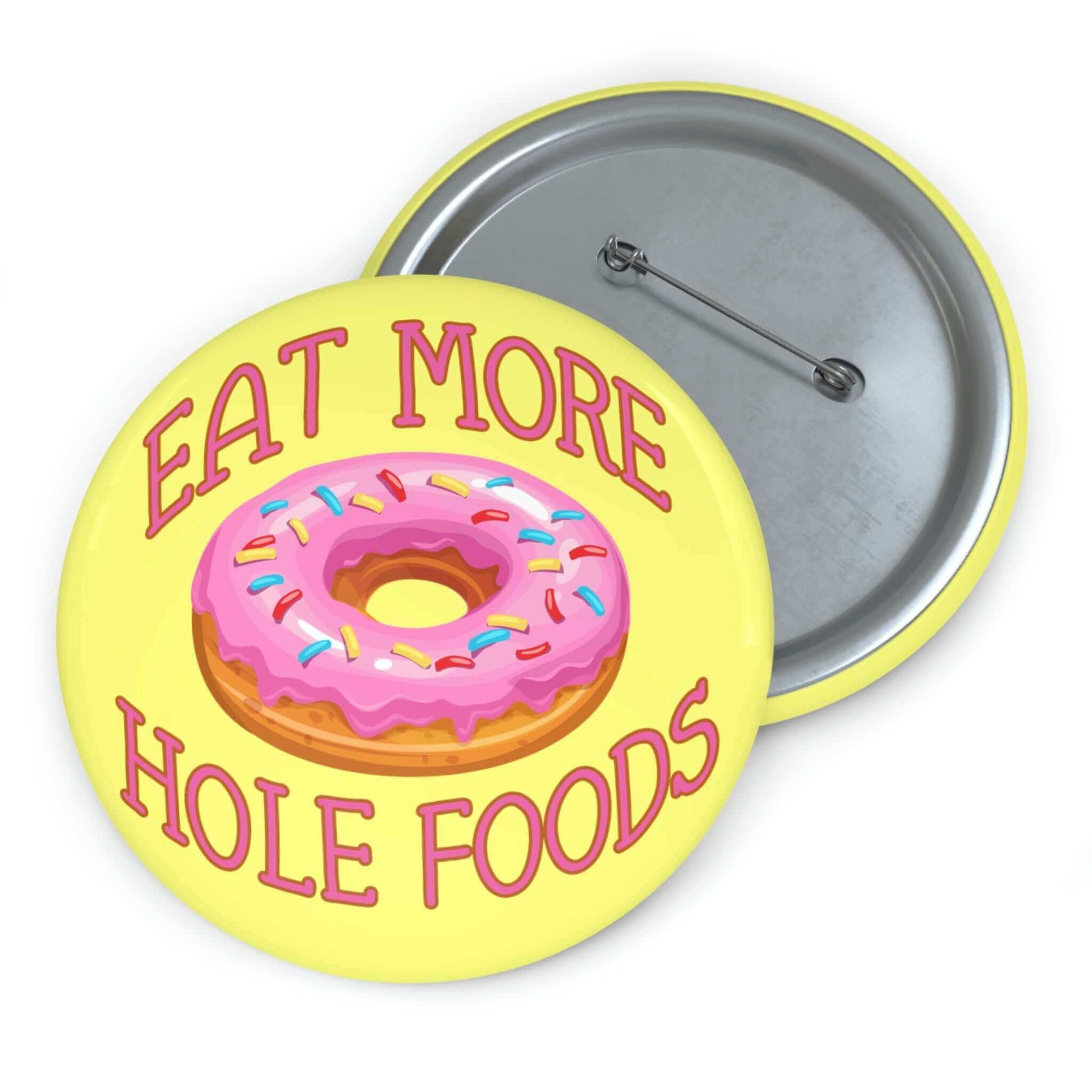 Funny donut pun pinback button with image of a donut with pink icing and sprinkles with the words Eat more hole foods.