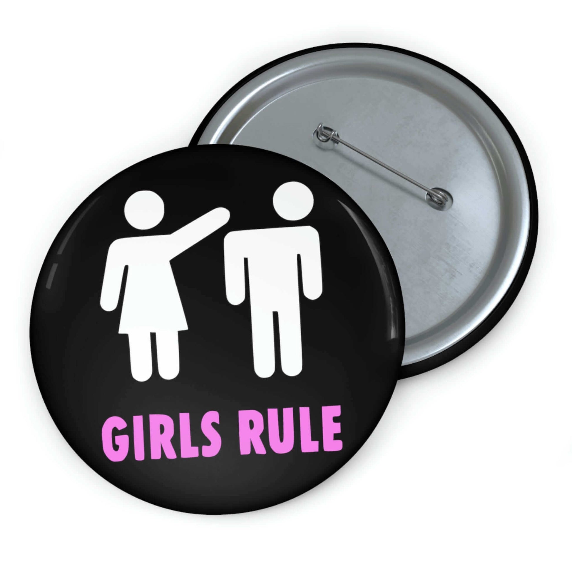 Black pin-back button with white stick figure man and woman. The woman is punching the mans head off and the words Girls rule is printed beneath in hot pink.