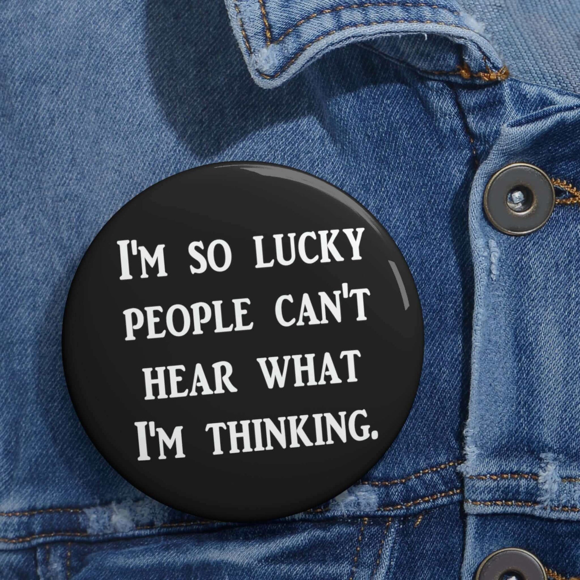 Black pinback button that says I'm so lucky people can't hear what I'm thinking.