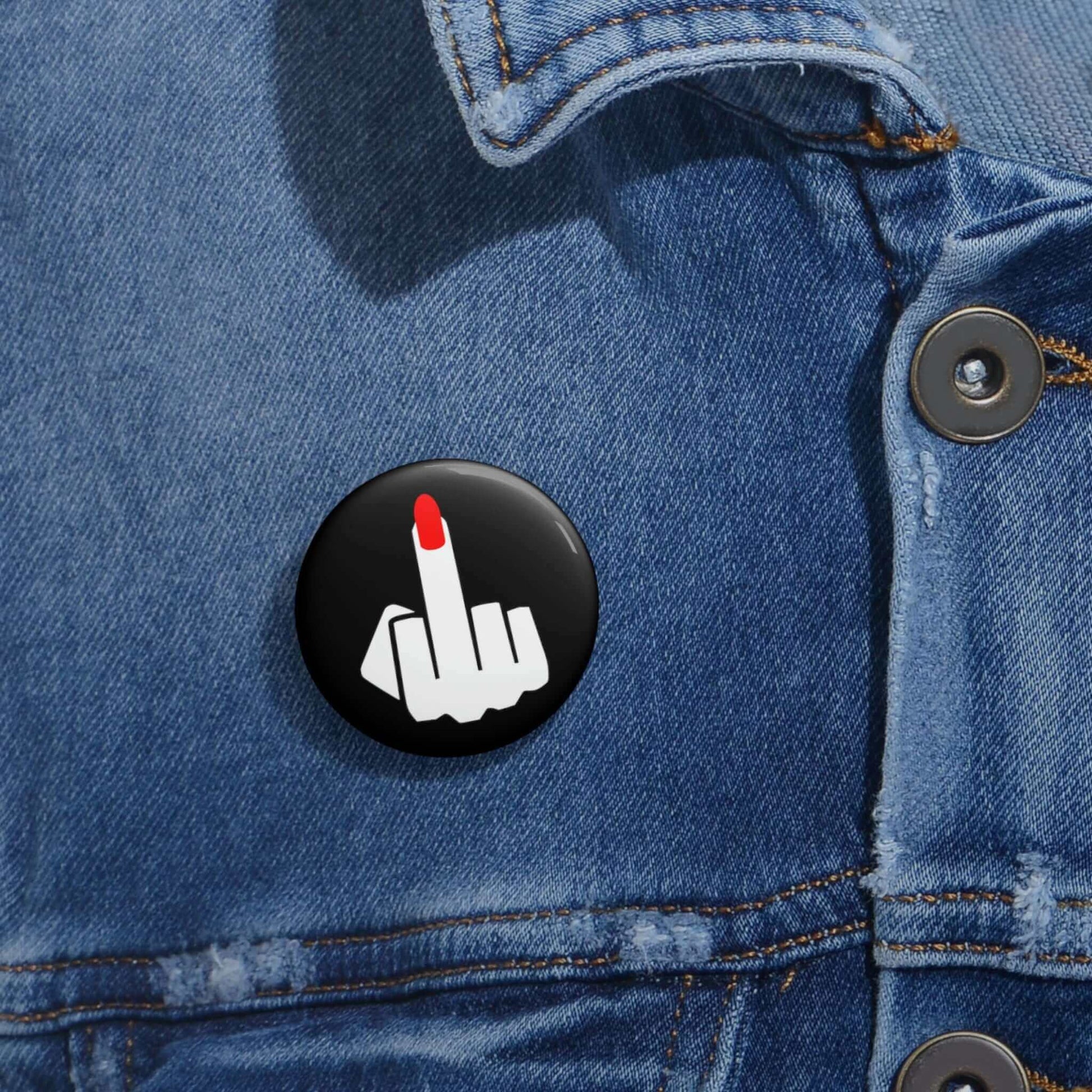 Pin-back button with silhouette of a ladies hand flipping the middle finger with a long red fingernail.