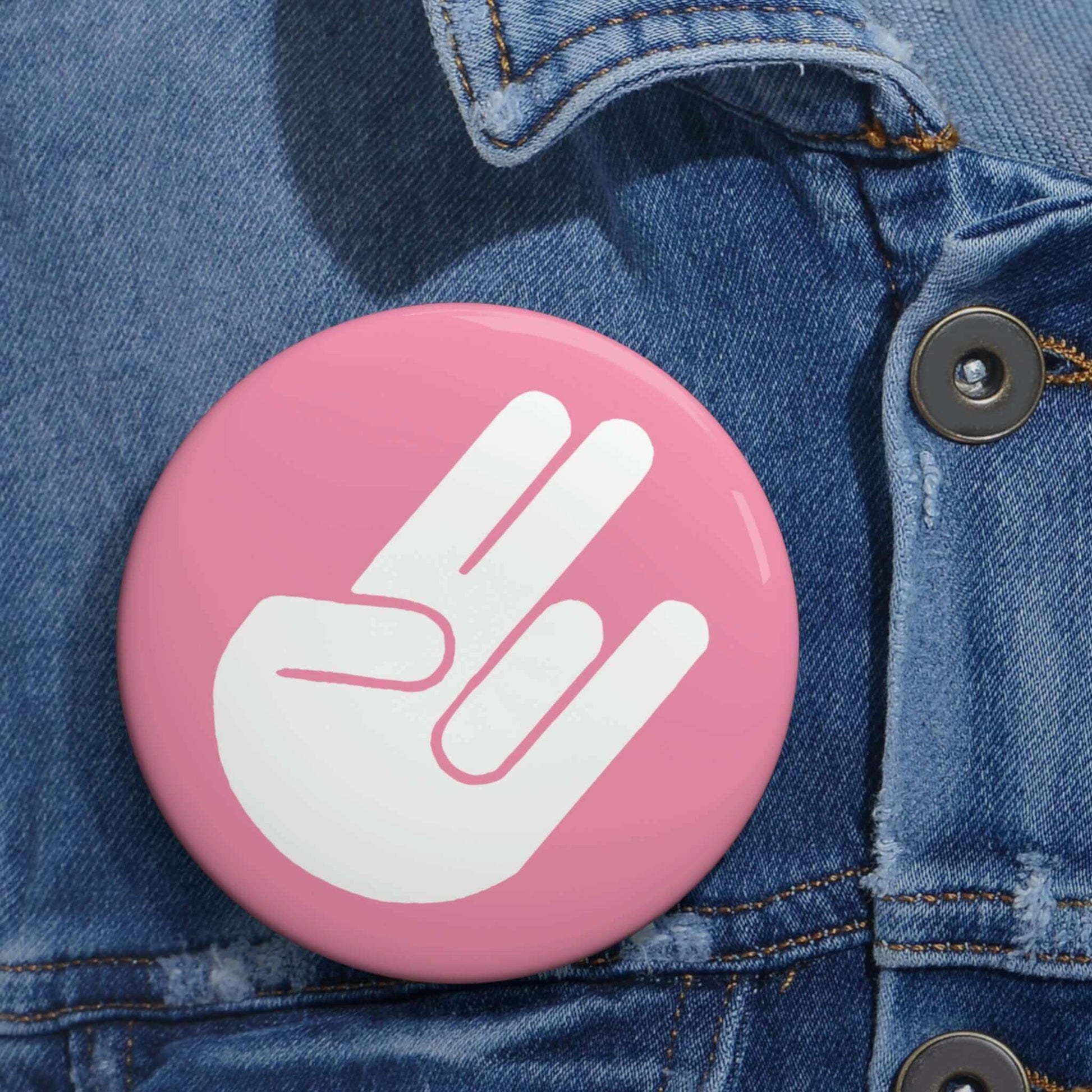 The shocker symbol on pink background pinback button.