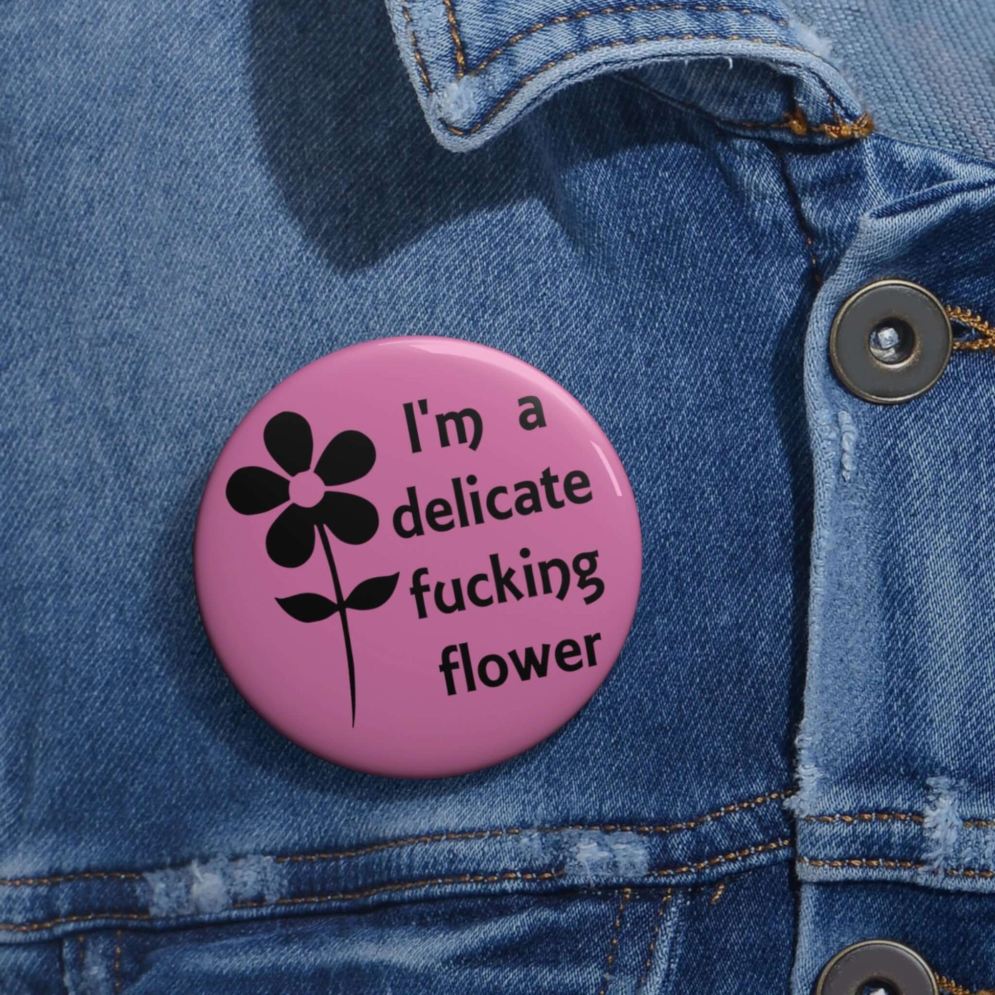 Pink pinback button with image of a flower and the words I'm a delicate fucking flower.