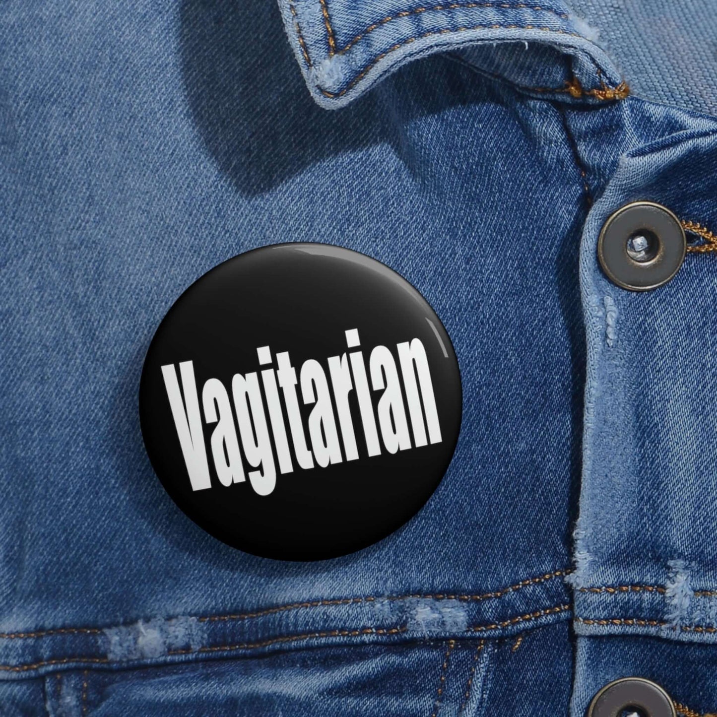 Black pinback button with the word Vagitarian printed on it.