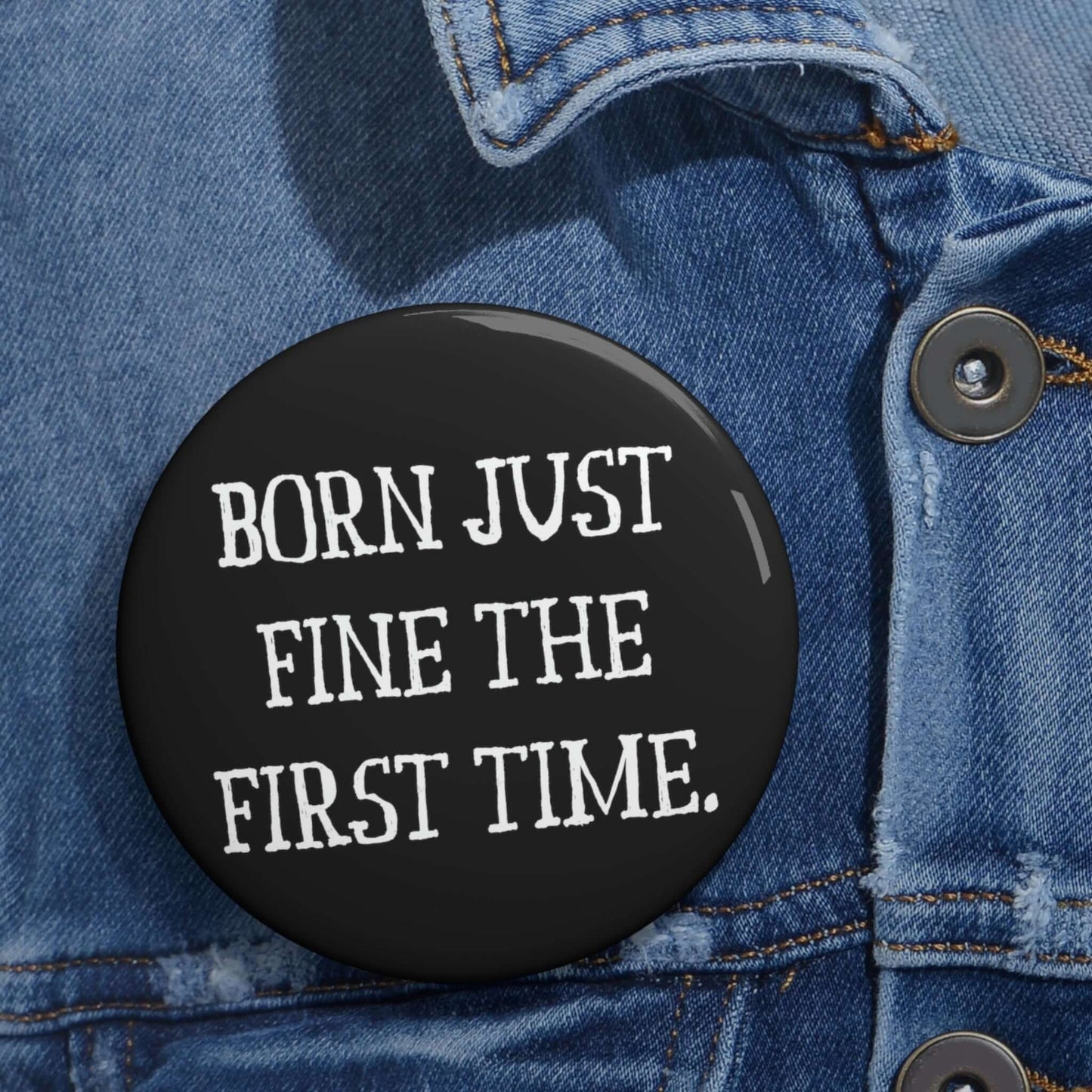 Black pinback button that says Born just fine the first time.