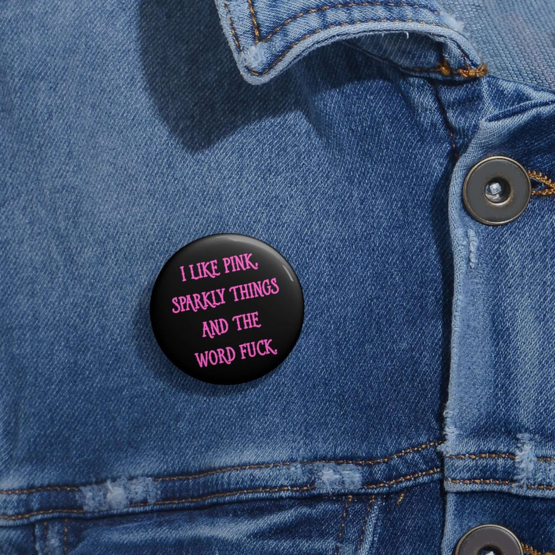 Pin-back button that says I like pink, sparkly things and the word fuck printed in pink font.