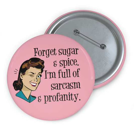 Pink pin-back button with image of winking retro woman and the words Forget sugar and spice, I'm full of sarcasm and profanity.