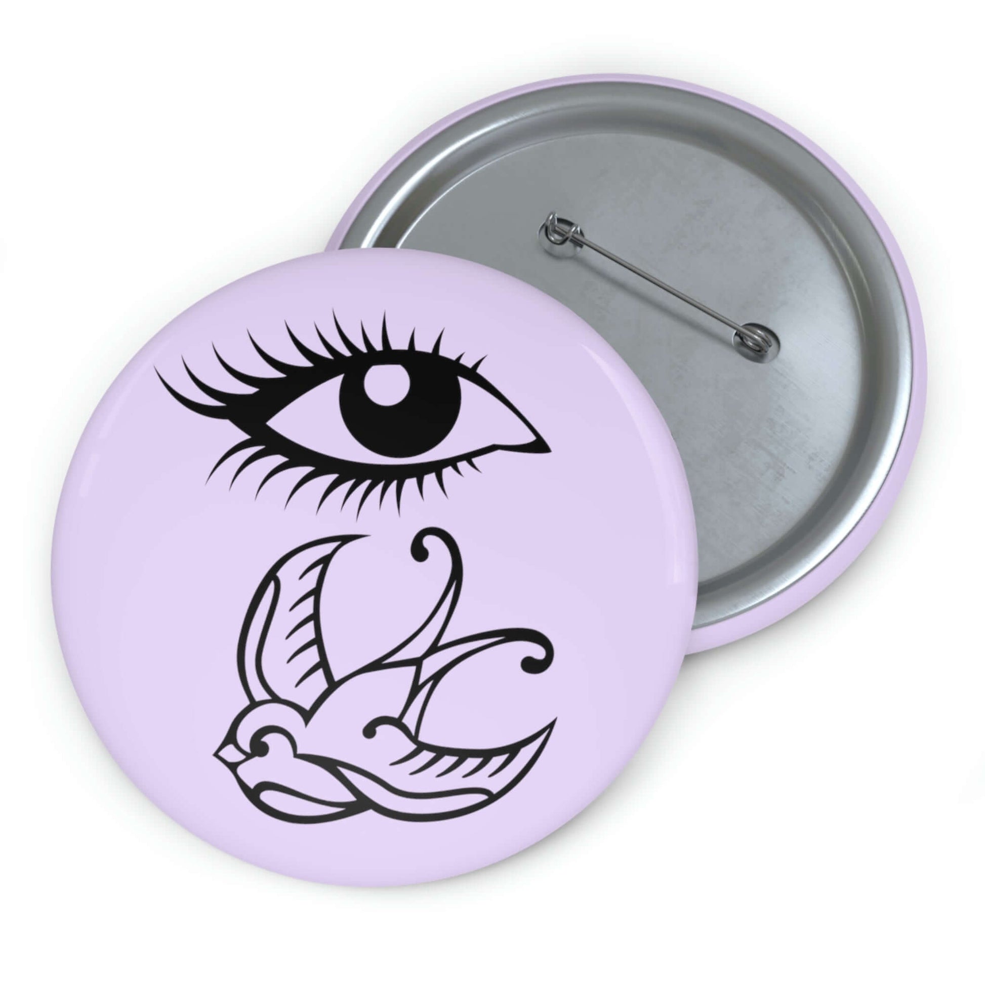 Pin-back button with image of an eye and a swallow bird on a light lavender background.