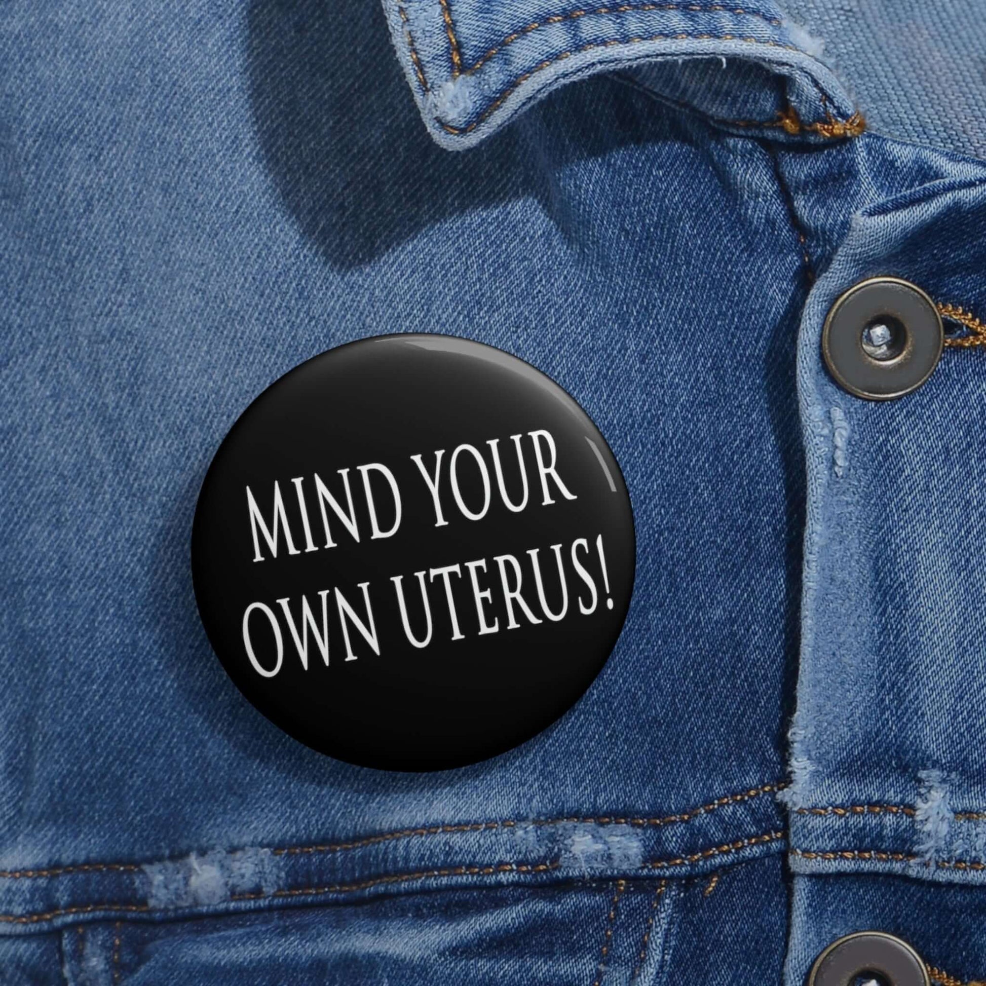 Pin-back button that says Mind your own uterus. 