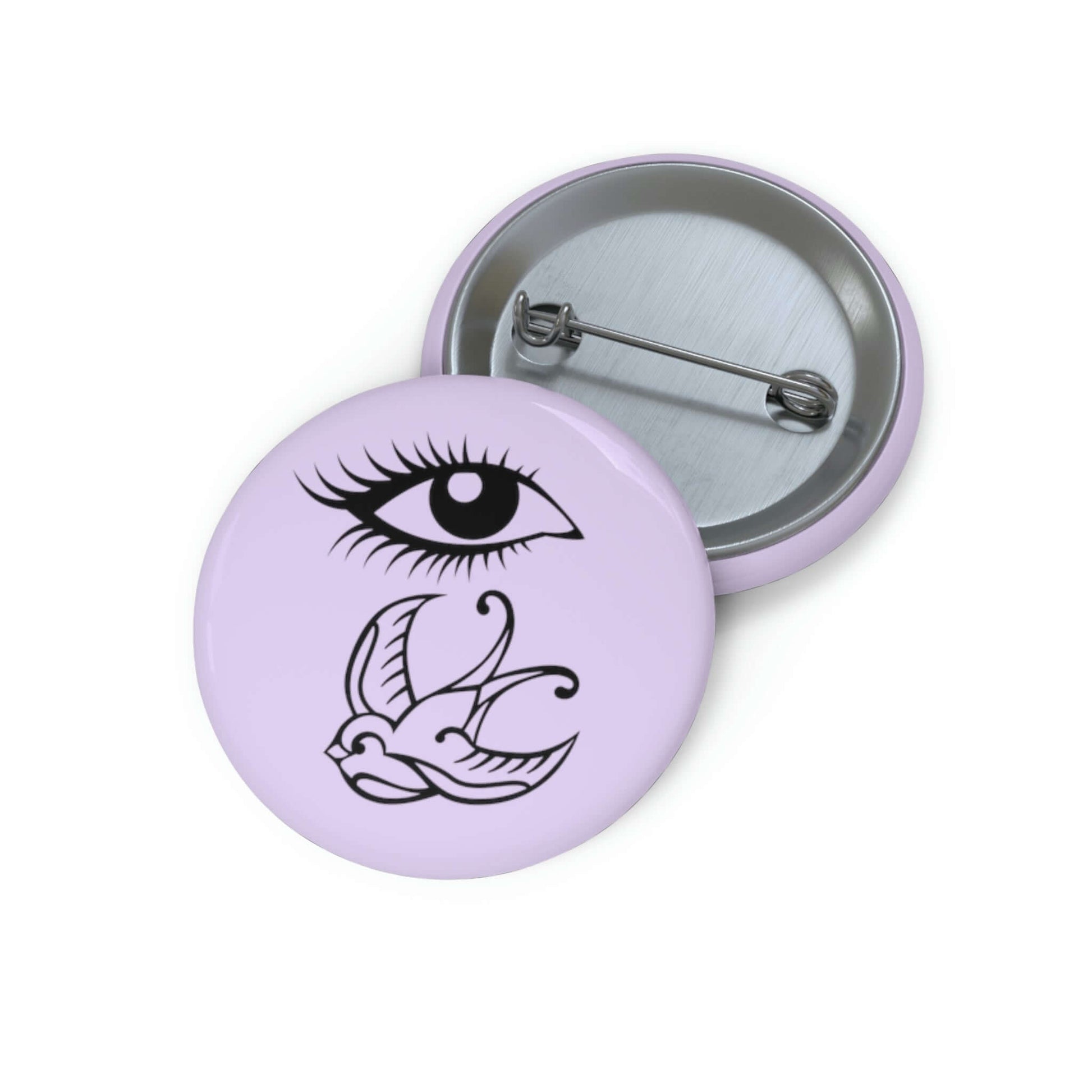 Pin-back button with image of an eye and a swallow bird on a light lavender background.
