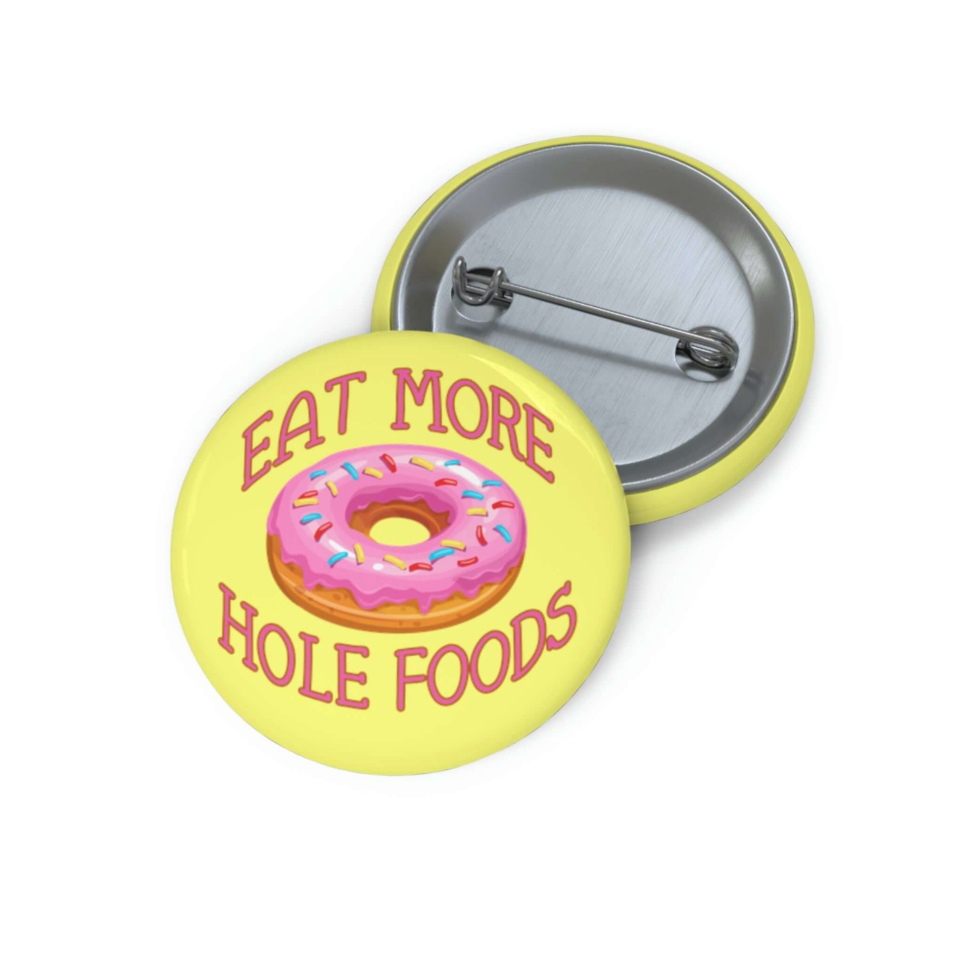 Funny donut pun pinback button with image of a donut with pink icing and sprinkles with the words Eat more hole foods.