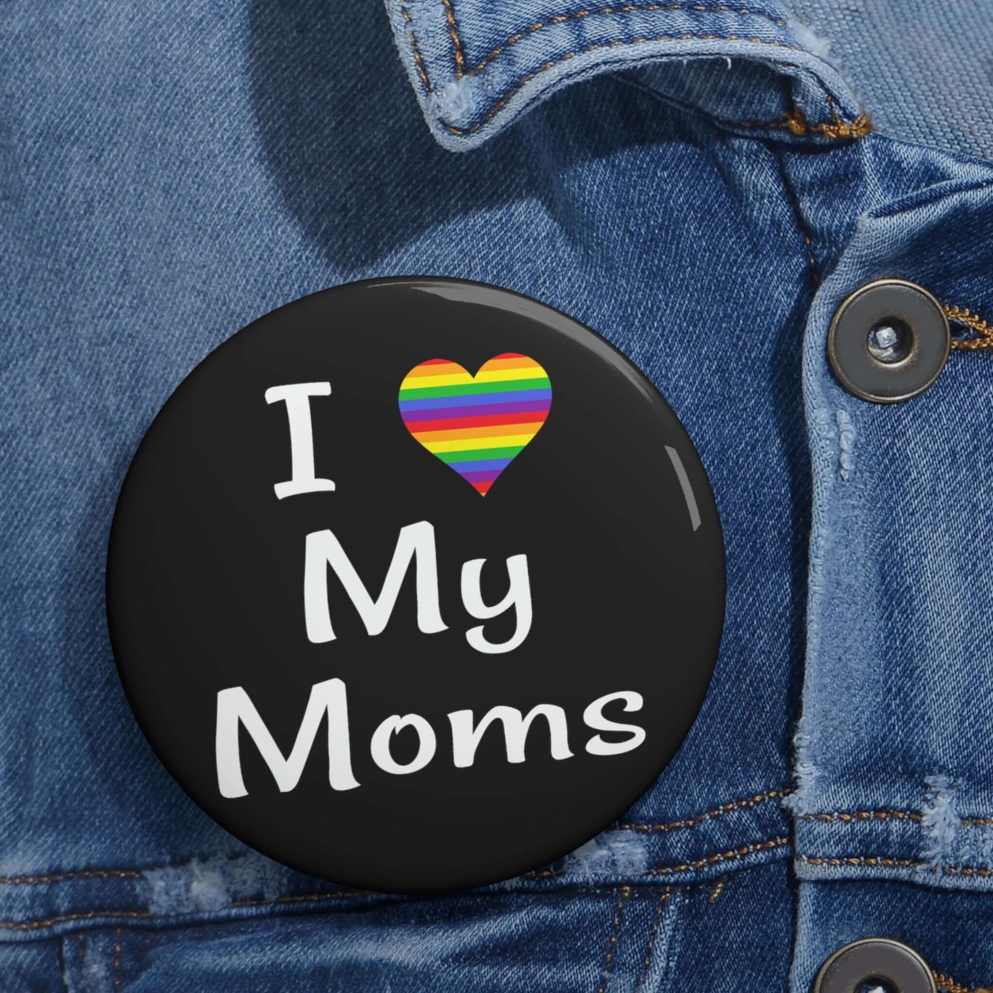 I heart love my moms pinback button. The heart is rainbow.