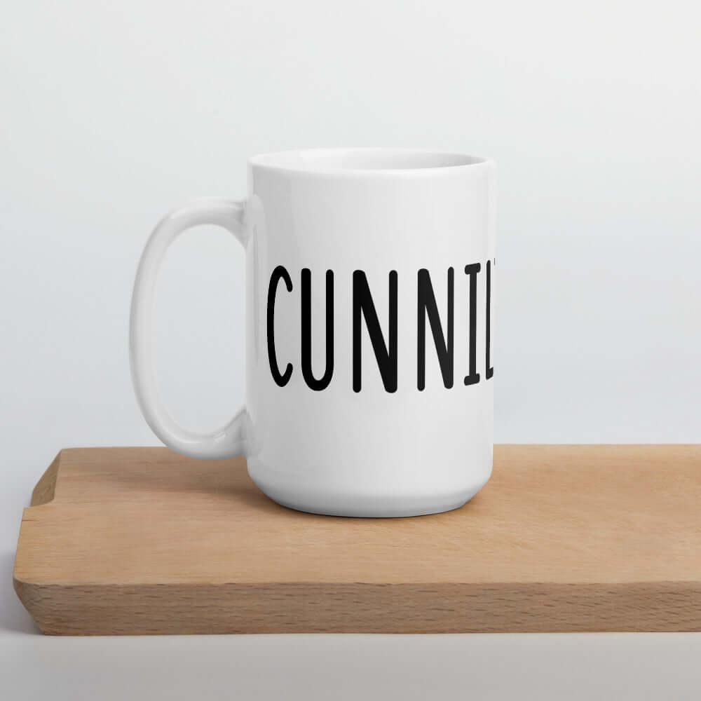 White ceramic coffee mug with the word Cunnilinguist printed on it. The word wraps all around the mug. 