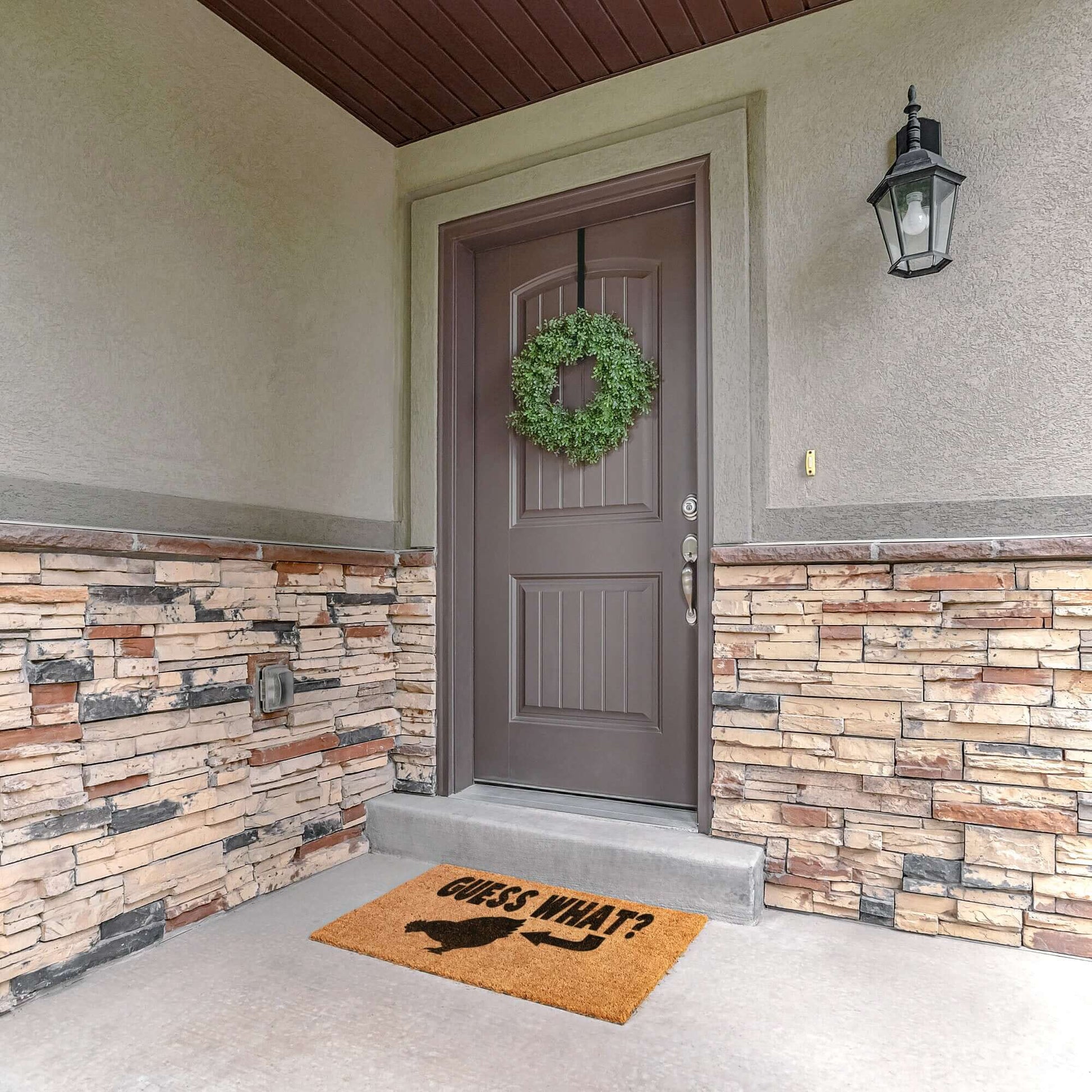 Tan color coconut coir fiber doormat with a Guess what chicken butt graphic printed in black.