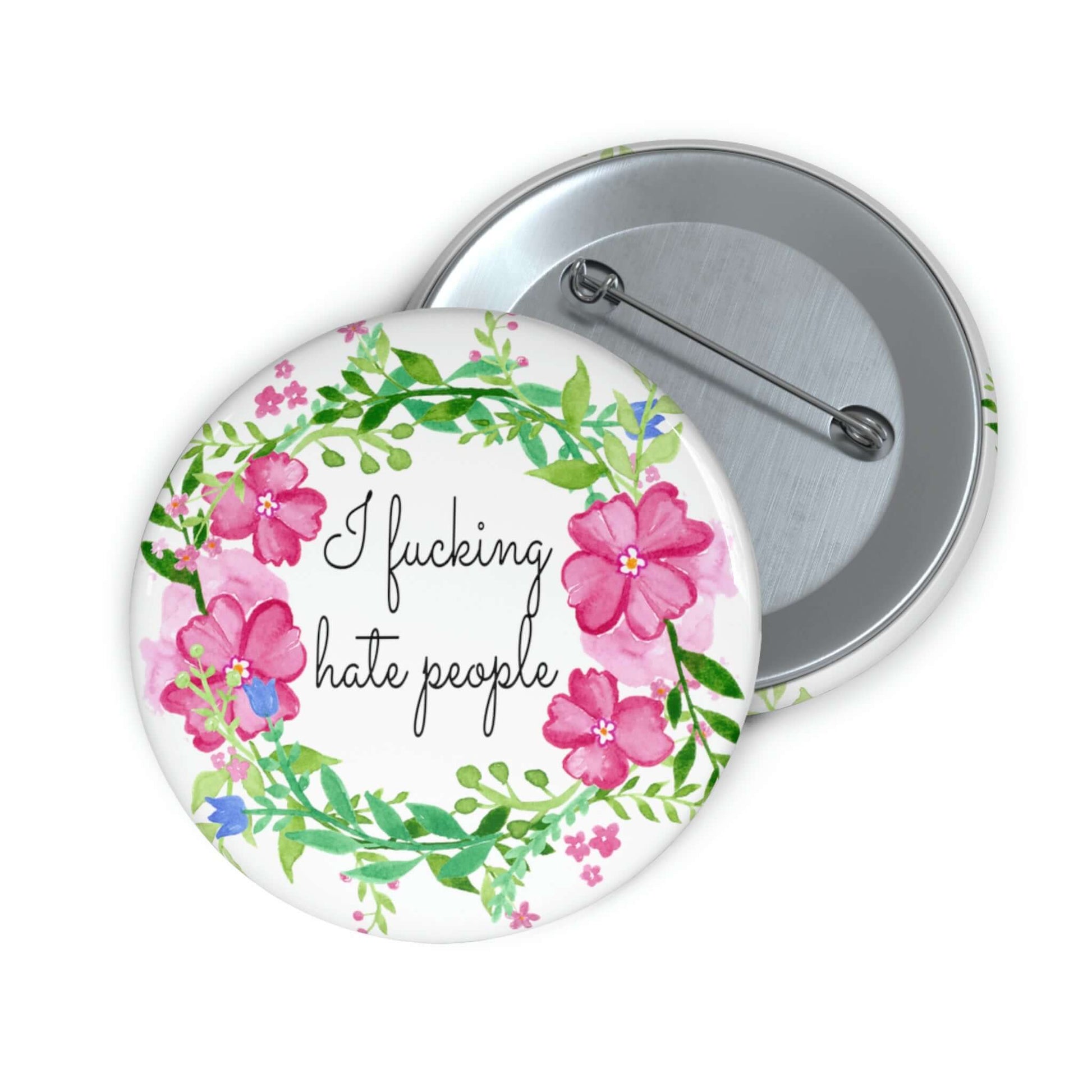 Pinback button with pink and green floral wreath image. The words I fucking hate people are in the center of the wreath.