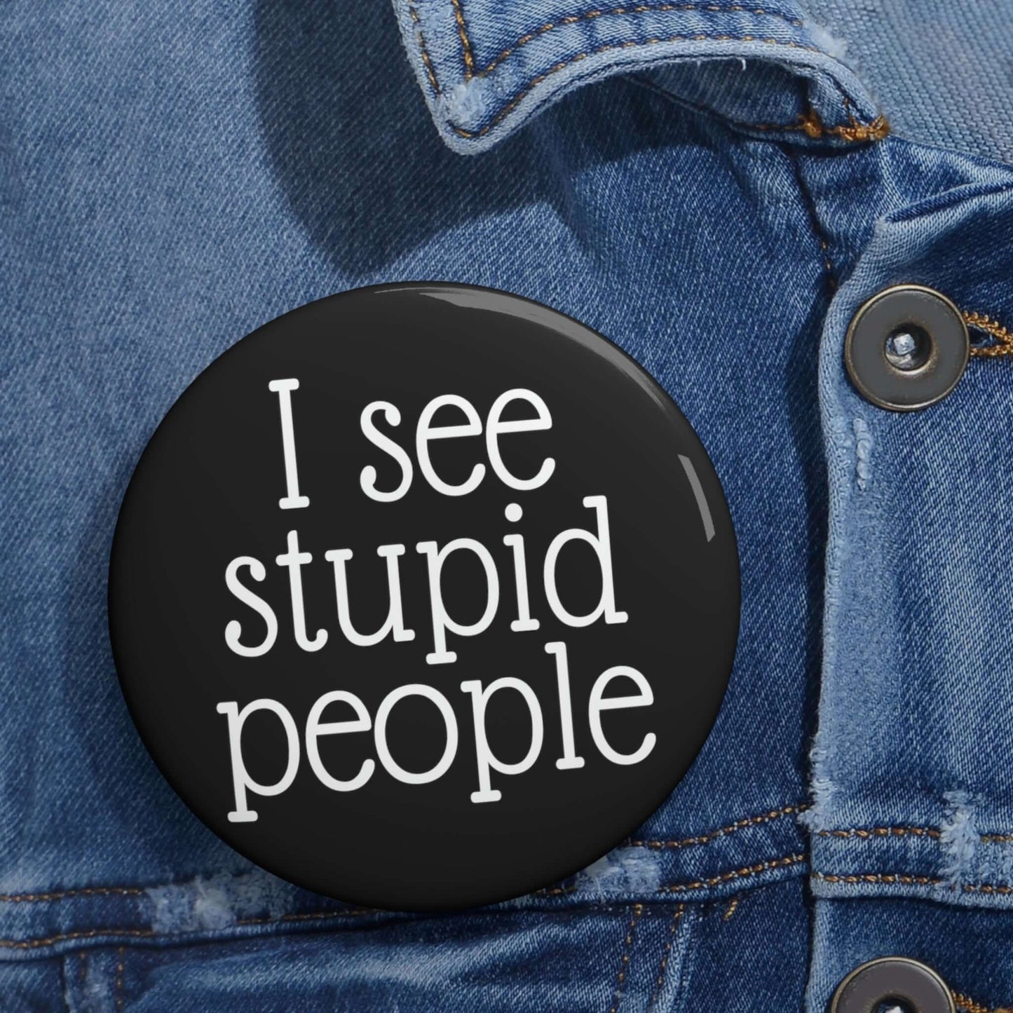 Black pinback button that says I see stupid people.