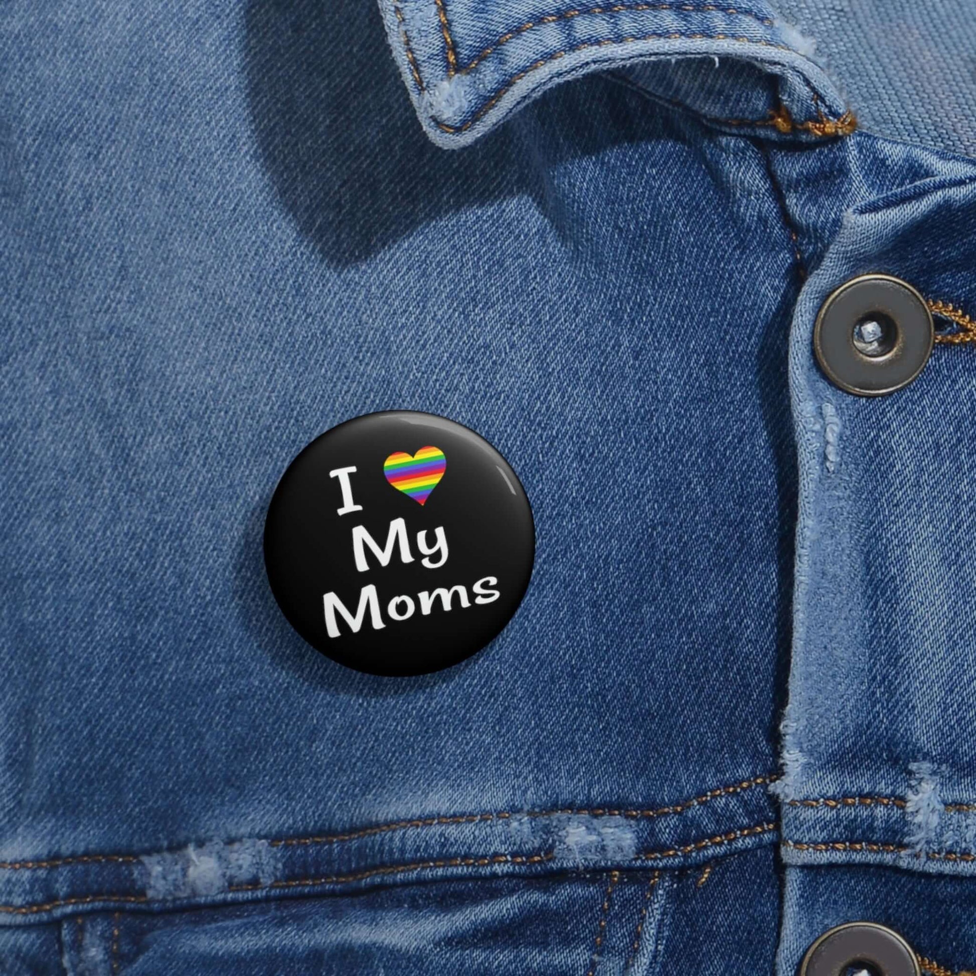 I heart love my moms pinback button. The heart is rainbow.