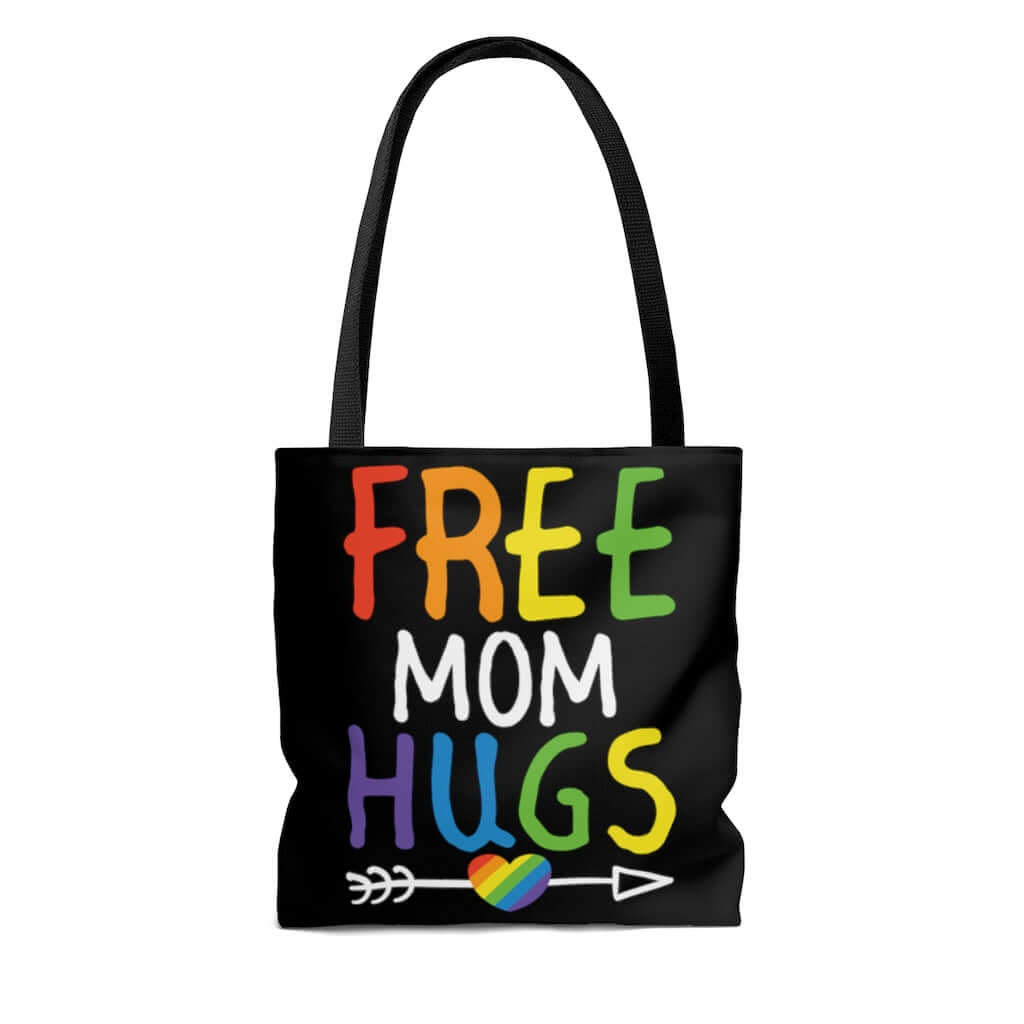 Black tote bag with the words Free Mom hugs in rainbow lettering printed on both sides.