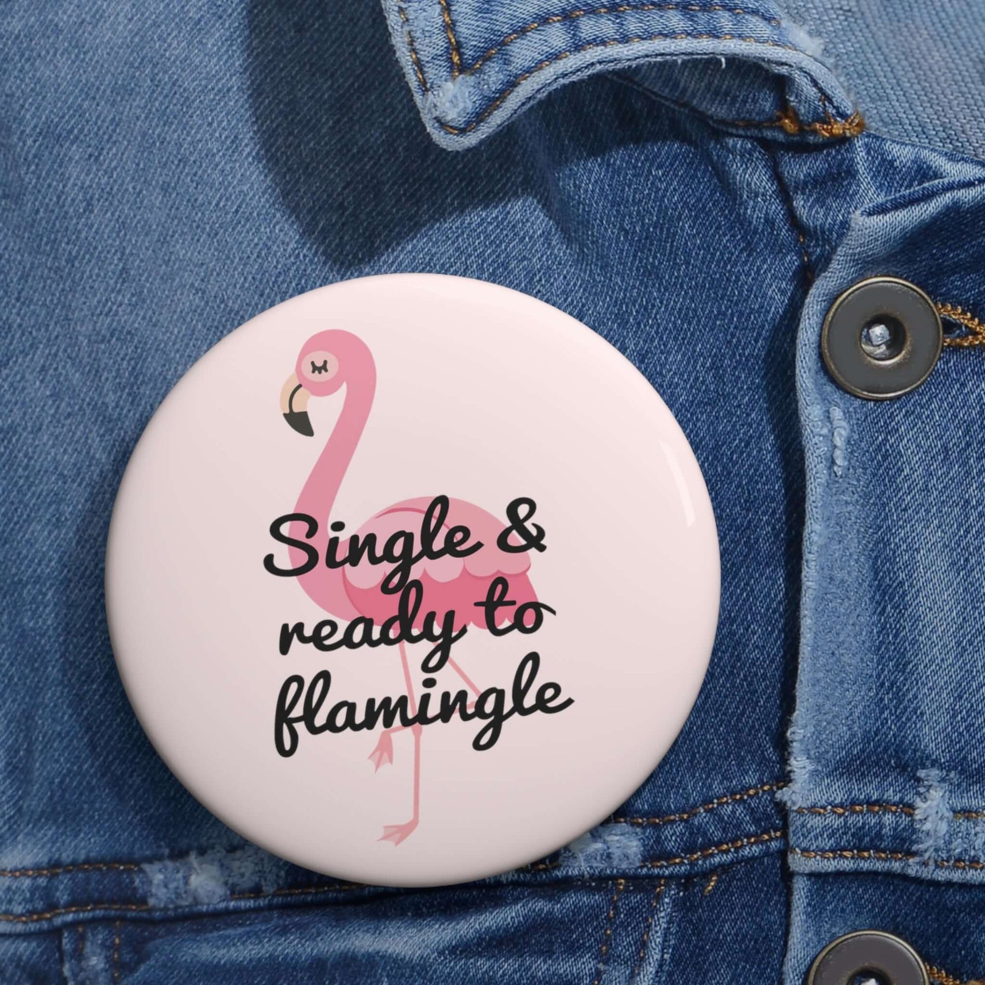 Pink pinback button with image of a flamingo and the words Single and ready to flamingle.