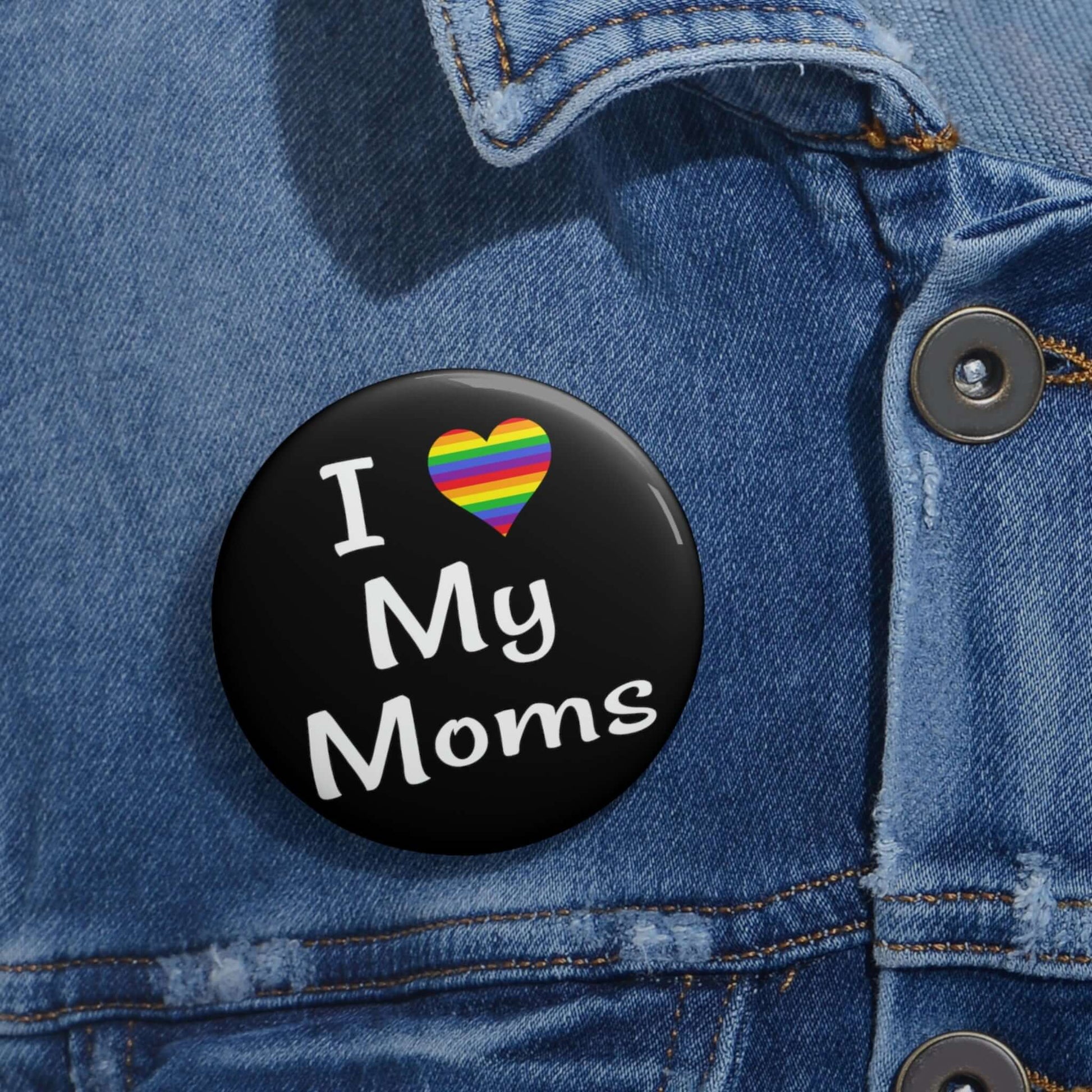 I heart love my moms pinback button. The heart is rainbow.