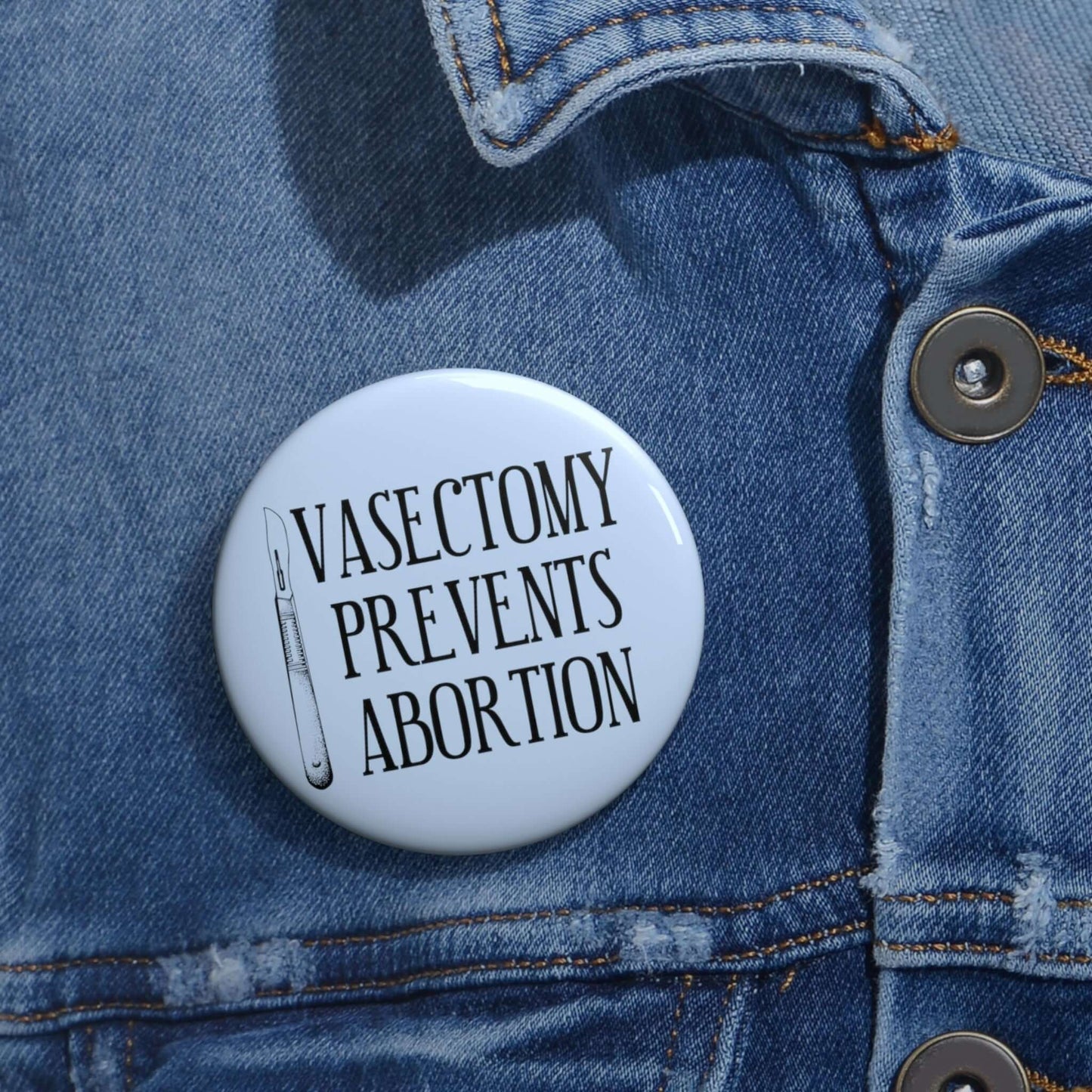 Light blue pinback button withe image of surgical scalpel and the words Vasectomy prevents abortion.