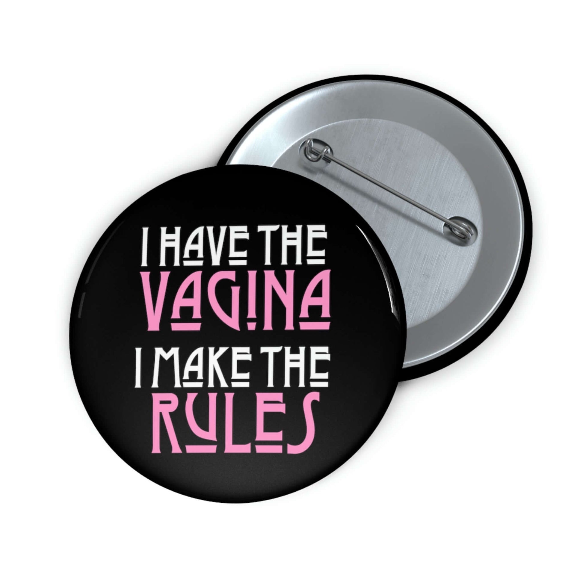 Pinback button that says I have the vagina , I make the rules. The words vagina and rules are pink, the rest of the words are white.