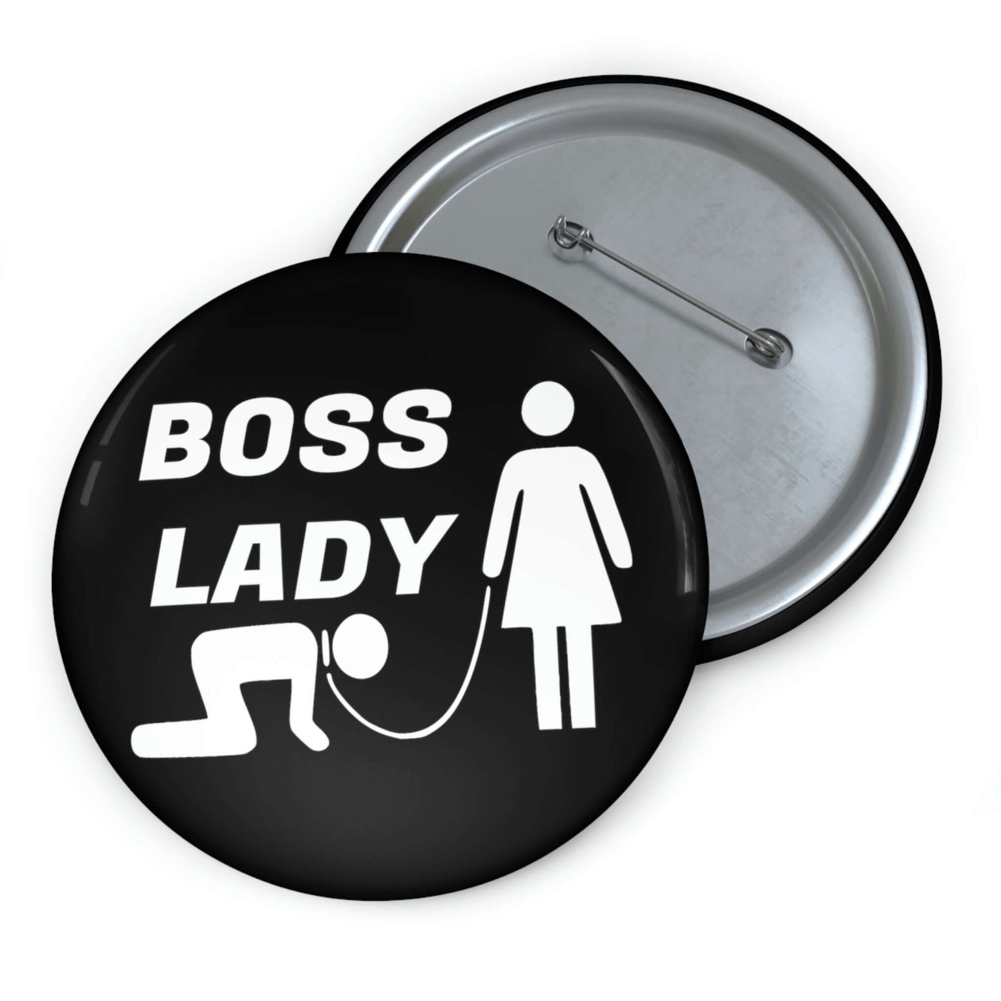 Black pinback button with graphic of collared and leashed man on his hands and knees being led by a woman and the words Boss lady.