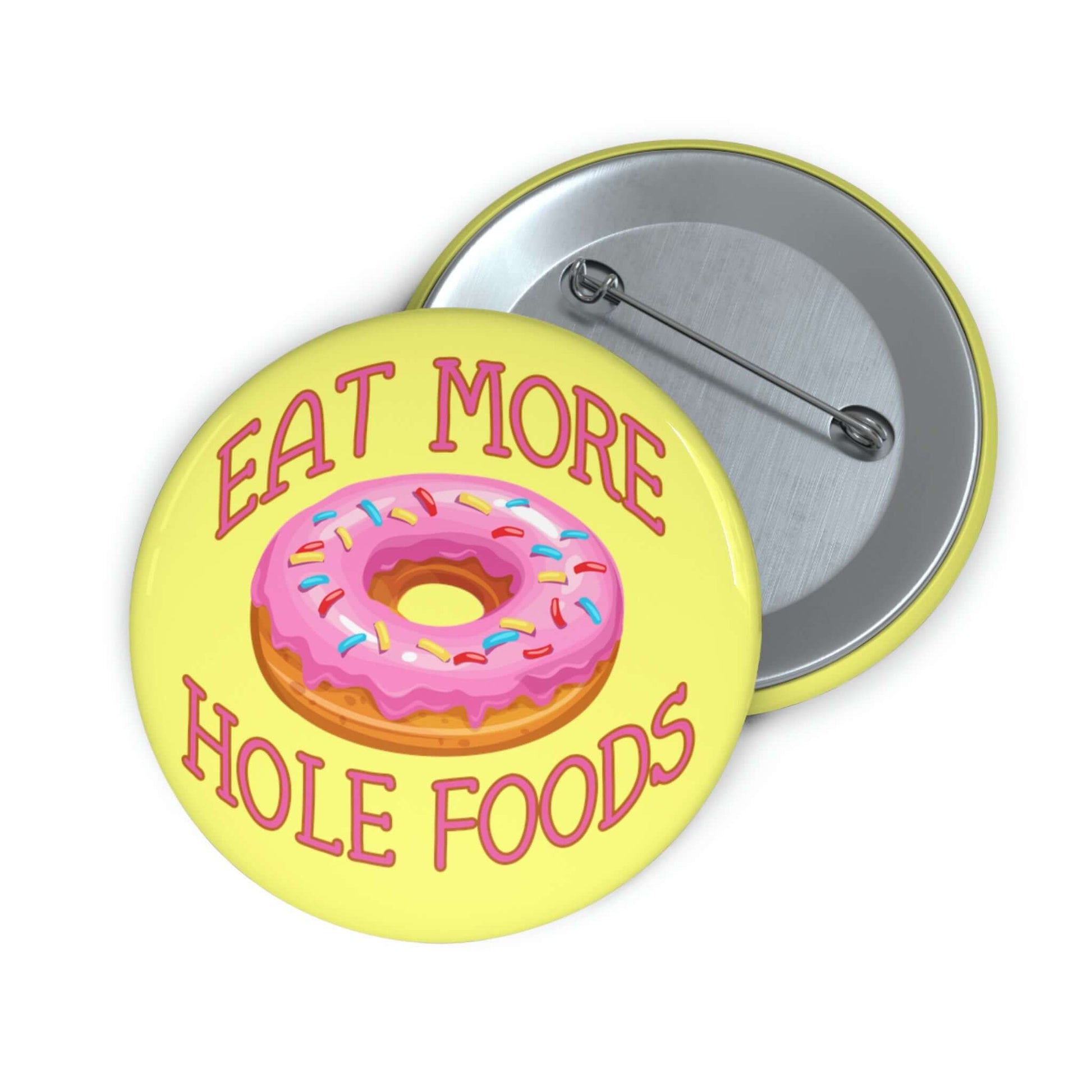 Funny donut pun pinback button with image of a donut with pink icing and sprinkles with the words Eat more hole foods.