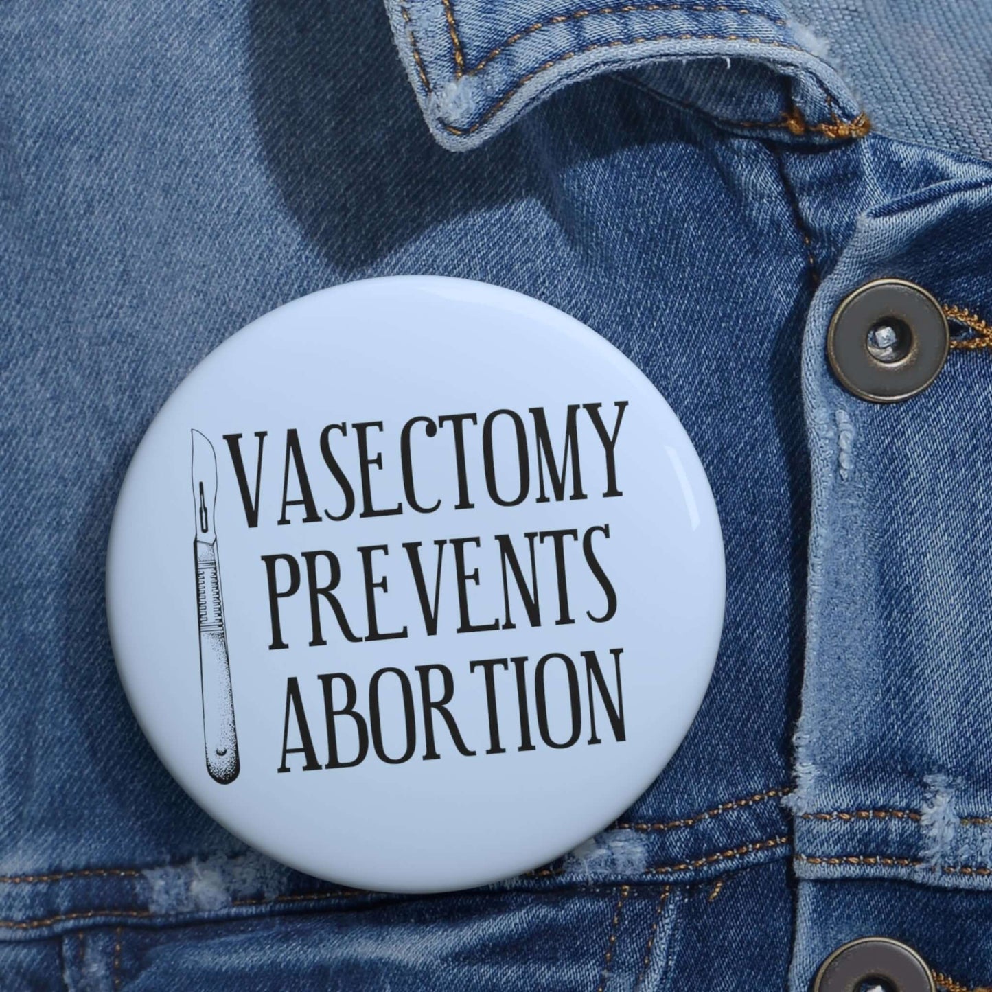 Light blue pinback button with image of surgical scalpel and the words Vasectomy prevents abortion.