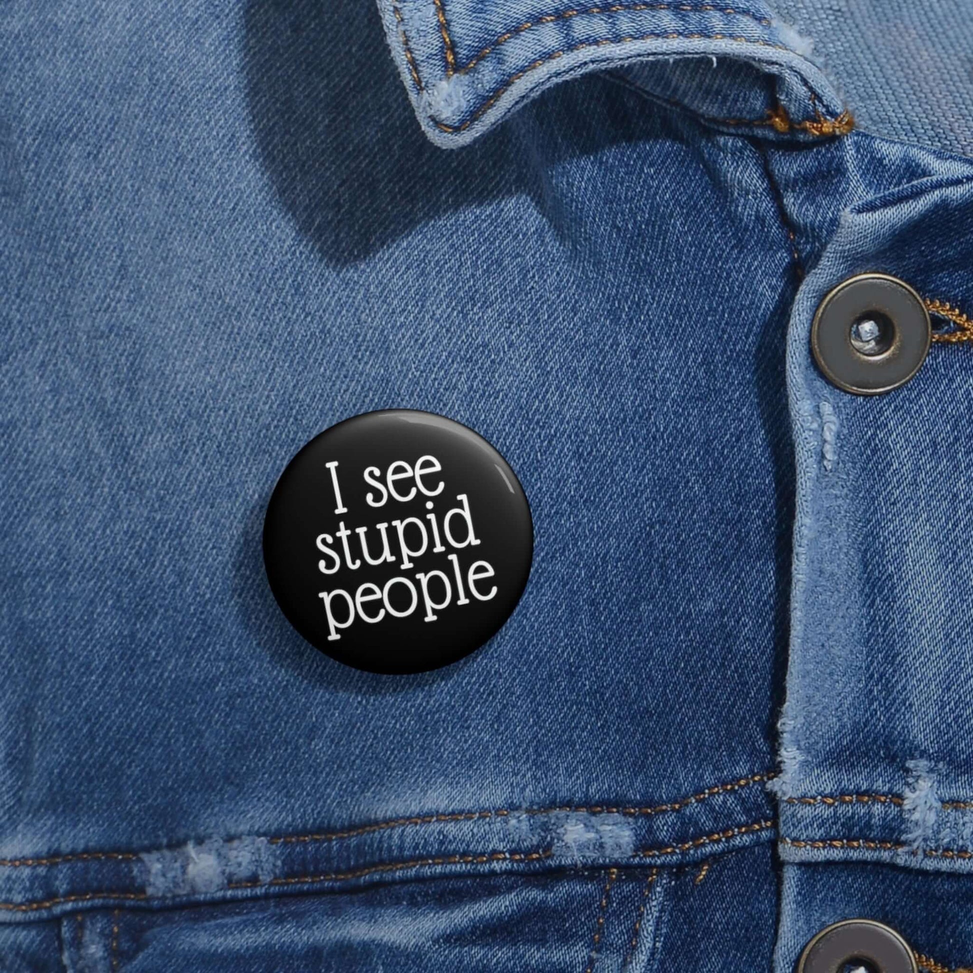 Black pinback button that says I see stupid people.