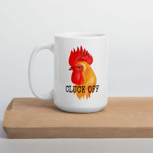 White ceramic mug pun that has graphic of a chicken and the words Cluck off printed on both sides.