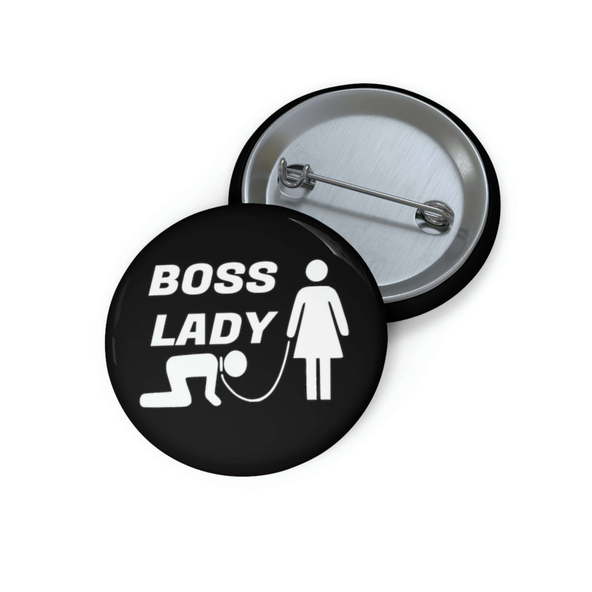 Black pinback button with graphic of collared and leashed man on his hands and knees being led by a woman and the words Boss lady.