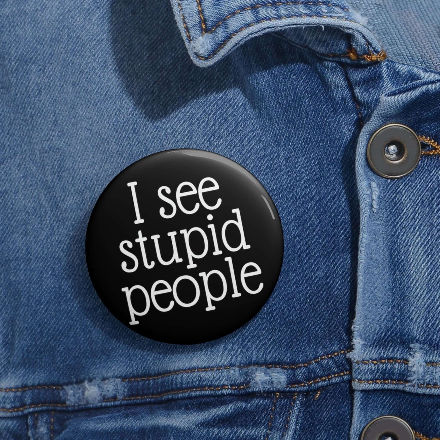 Black pinback button that says I see stupid people.