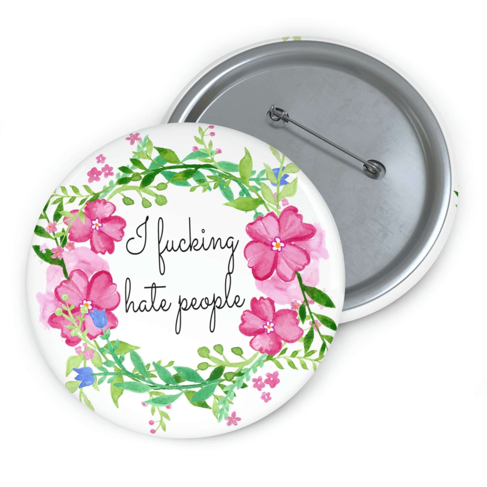 Pinback button with pink and green floral wreath image. The words I fucking hate people are in the center of the wreath.