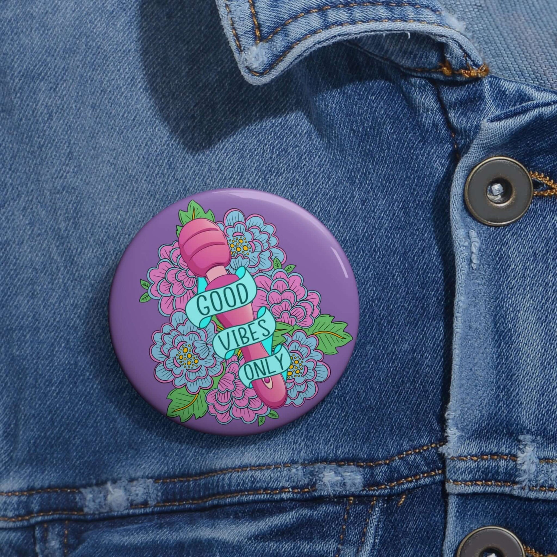 Pinback button with Good vibes only layered over a pink wand vibrator with flowers around and purple background.