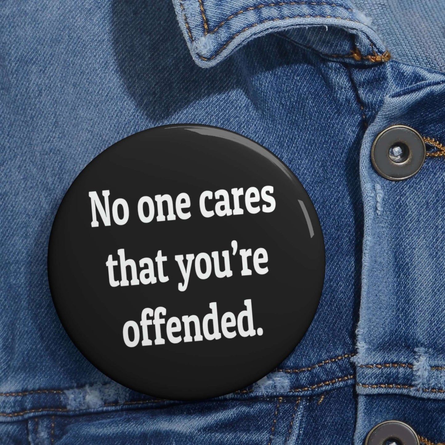 Pinback button that says No one cares that you're offended.