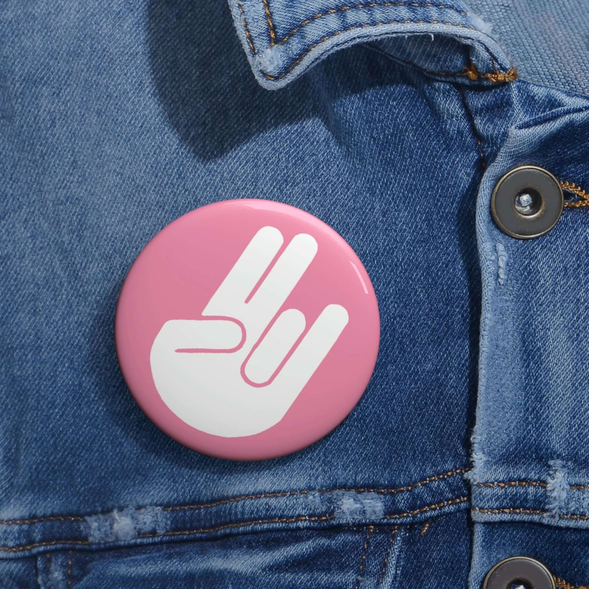 The shocker symbol on pink background pinback button.