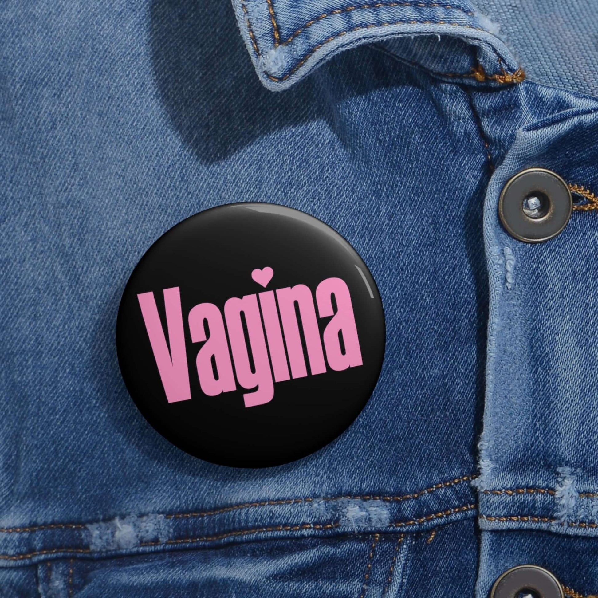 Black pinback button with the word Vagina printed in pink.