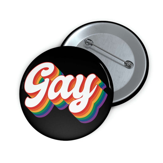 Black pinback button with the word gay in rainbow font.