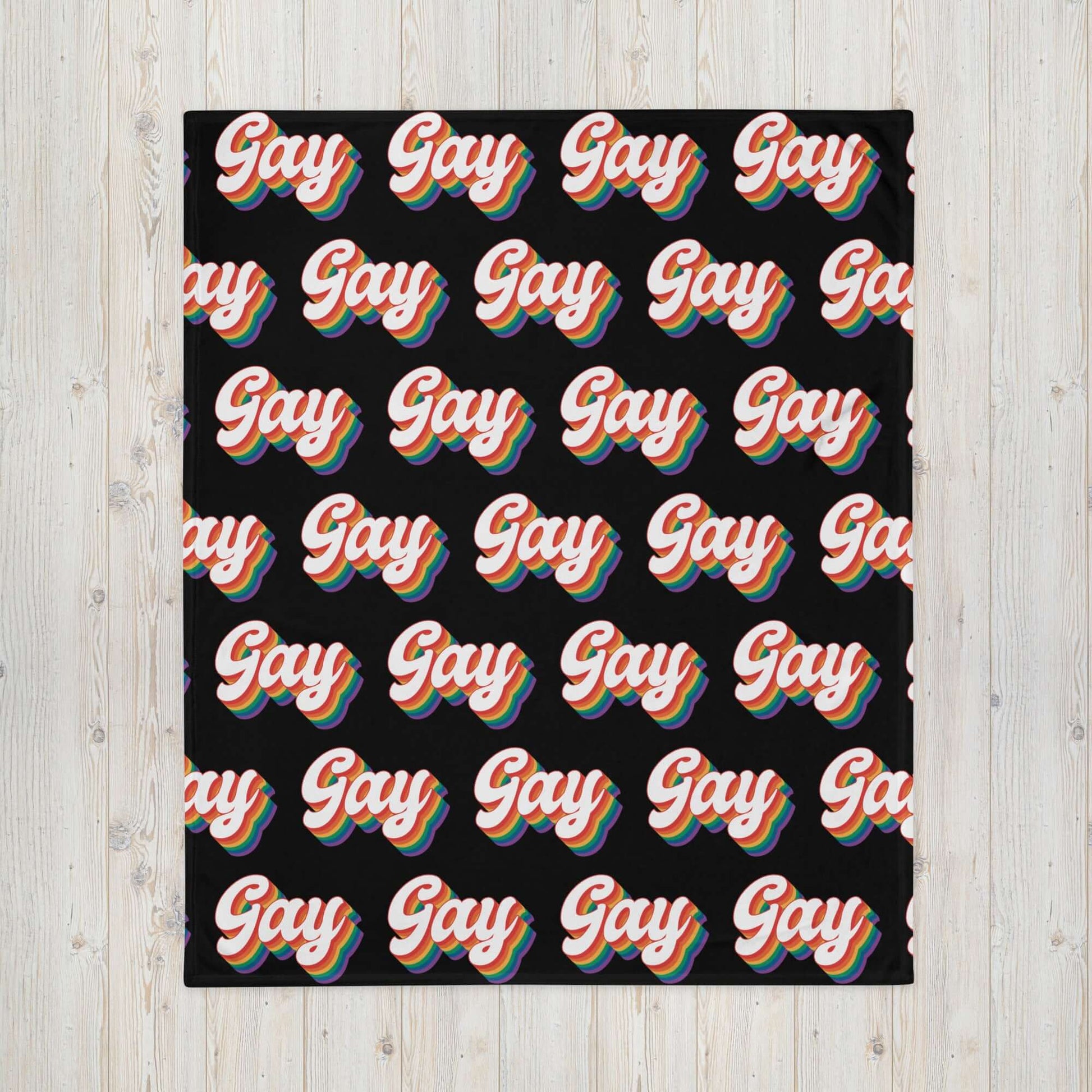 Black throw blanket with the word gay in rainbow font printed all over.