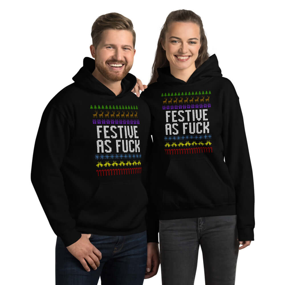 Man and woman standing next to each other. They are both wearing a black hoodie sweatshirt with the phrase Festive as fuck printed on the front.