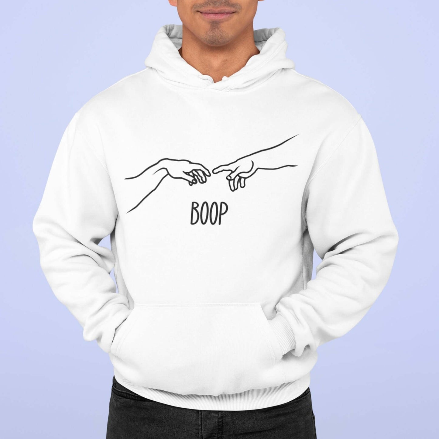 Man wearing white hoodie sweatshirt with line drawing hands reaching out and touching in the center like they in the famous art creation of Adam. The word Boop is printed underneath.