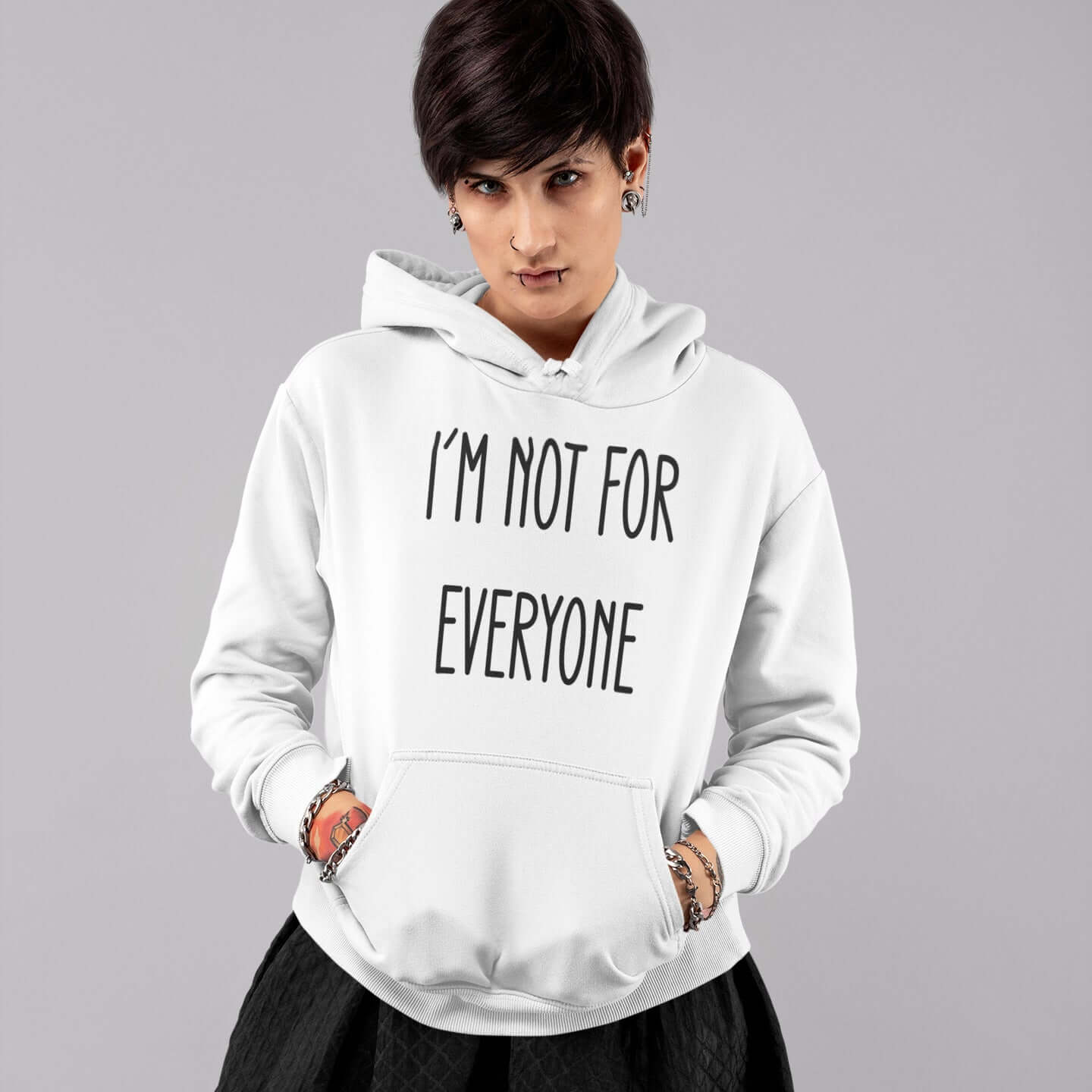 Woman wearing a white hoodie sweatshirt with the phrase I'm not for everyone printed on the front.