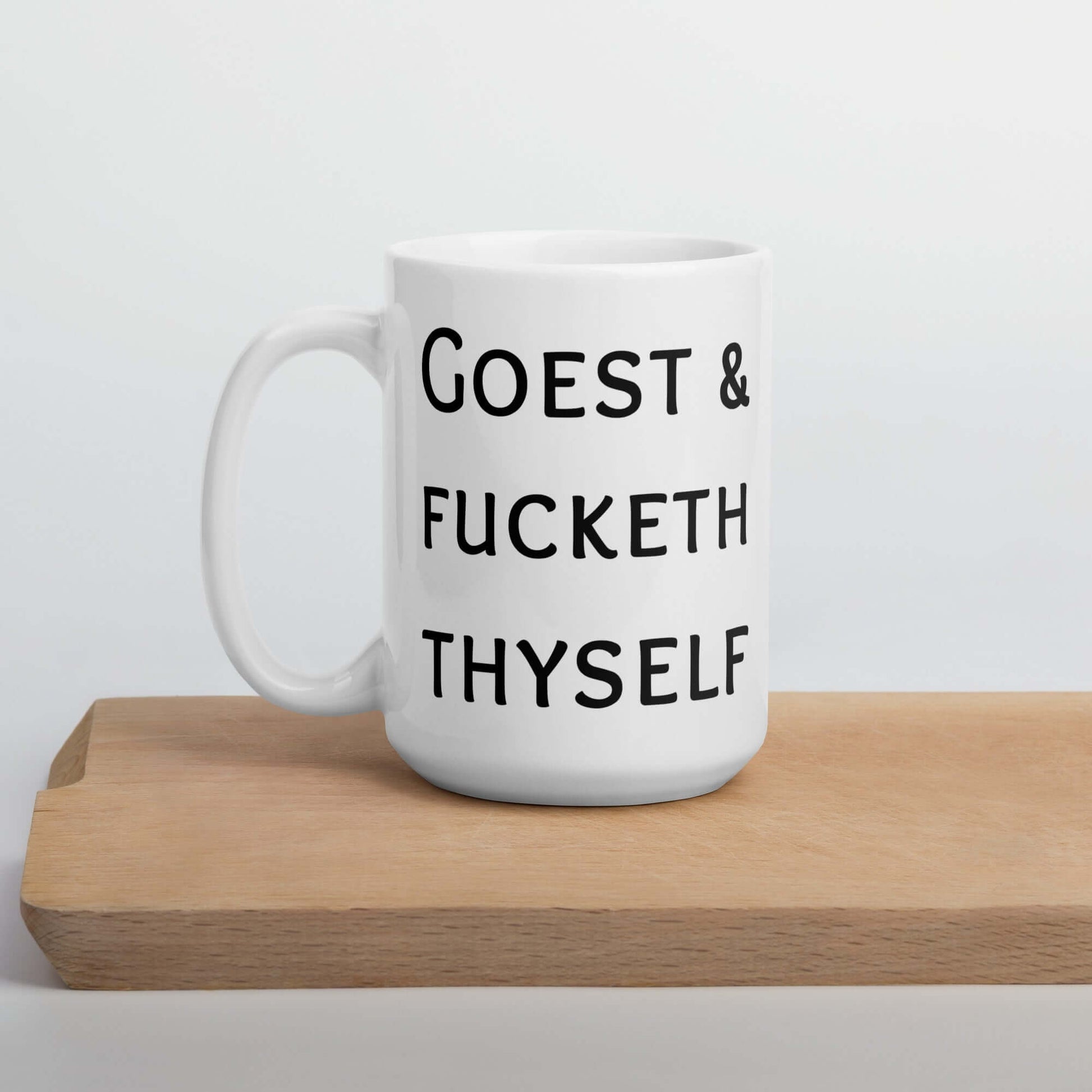 White ceramic mug with the words Goest and fucketh thyself printed on both sides.