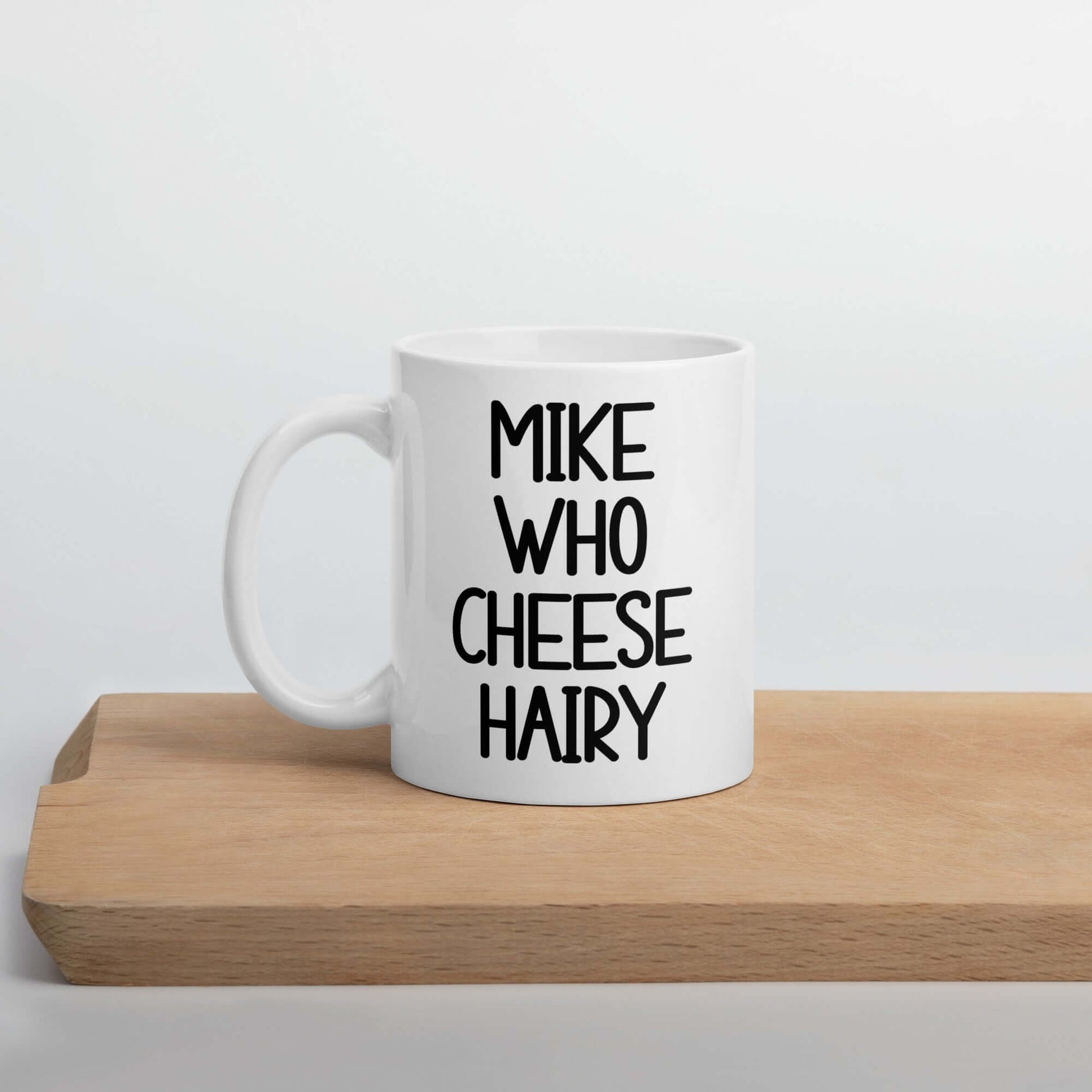 White ceramic pun mug with the words Mike who cheese hairy printed on both sides.